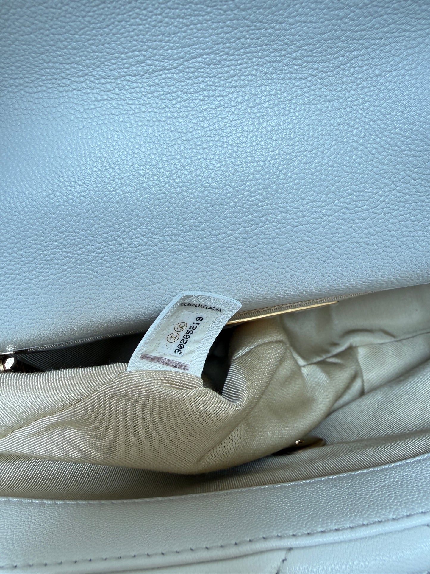 close up of serial number sticker for chanel 19 in white leather from purseonalshopper