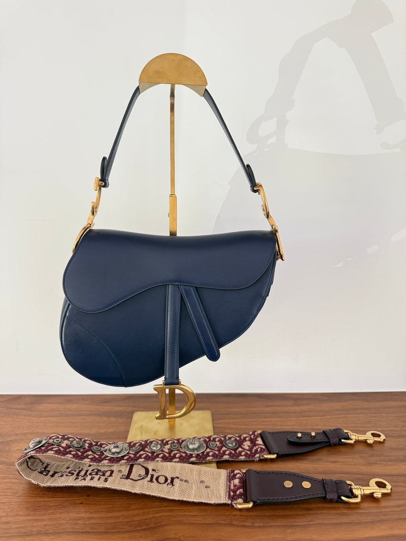 Dior saddle bag in smooth navy blue calfskin leather with burgundy Dior guitar strap authentic preowned from Purseonalshopper 