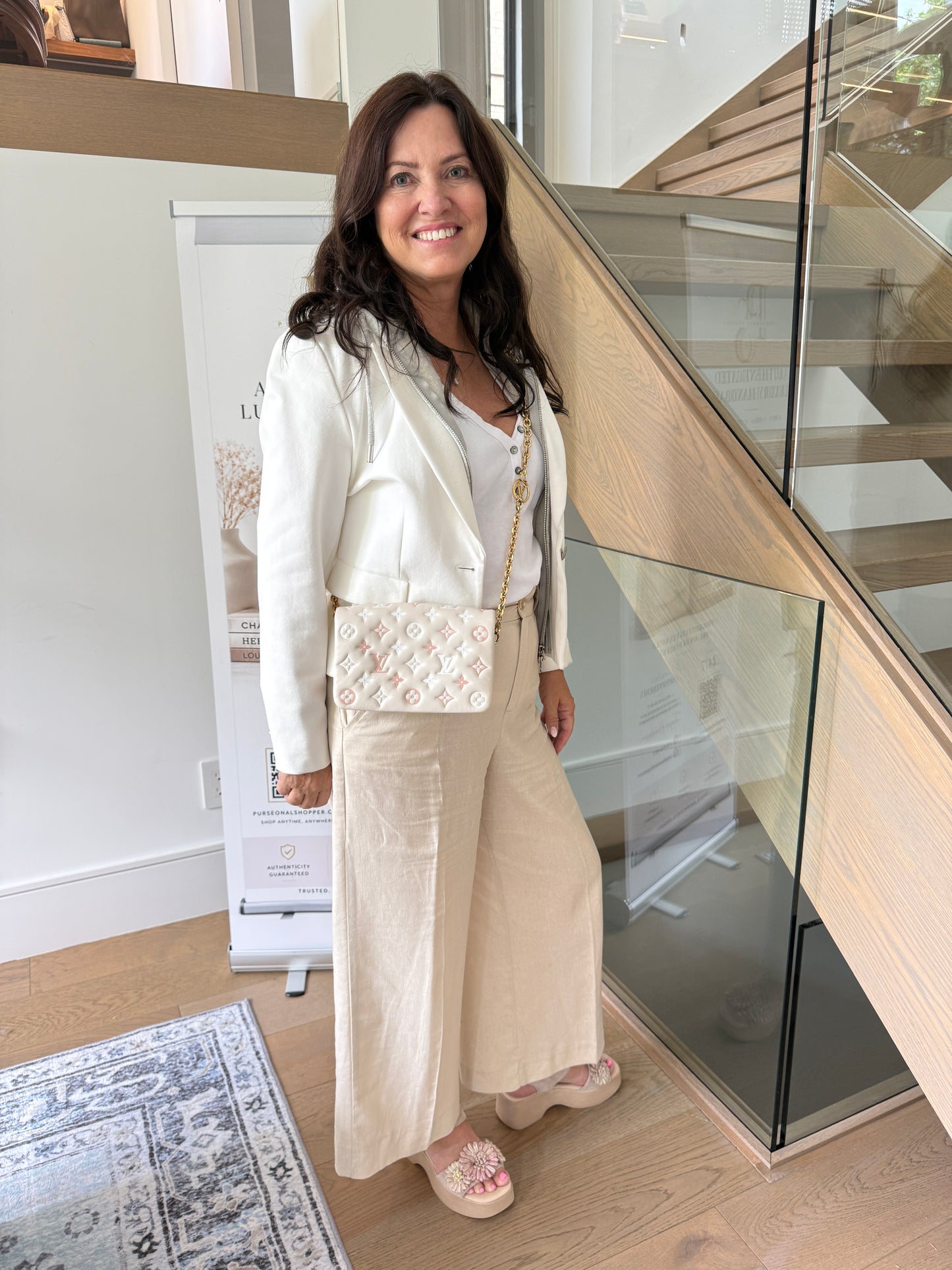 Louis Vuitton coussin pochette in cream shown on woman worn as a crossbody 