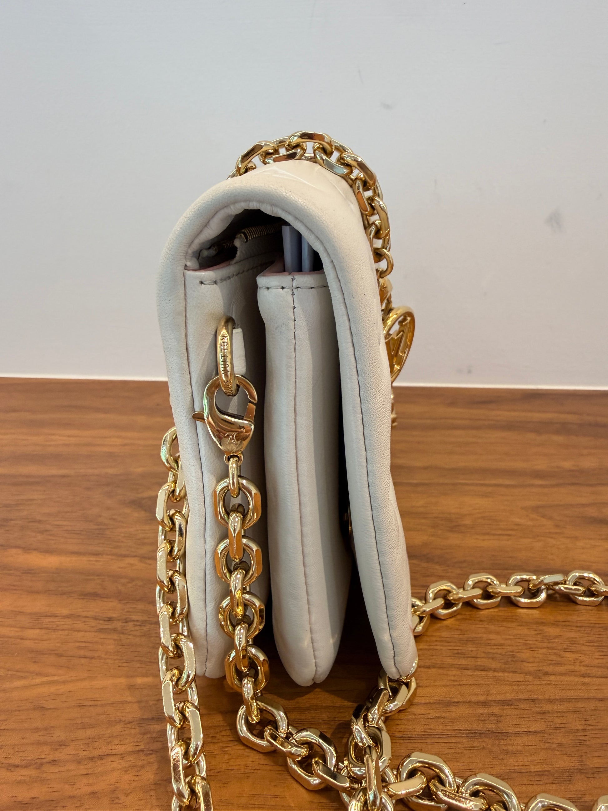 Louis Vuitton pochette coussin in cream side view of handbag for sale
