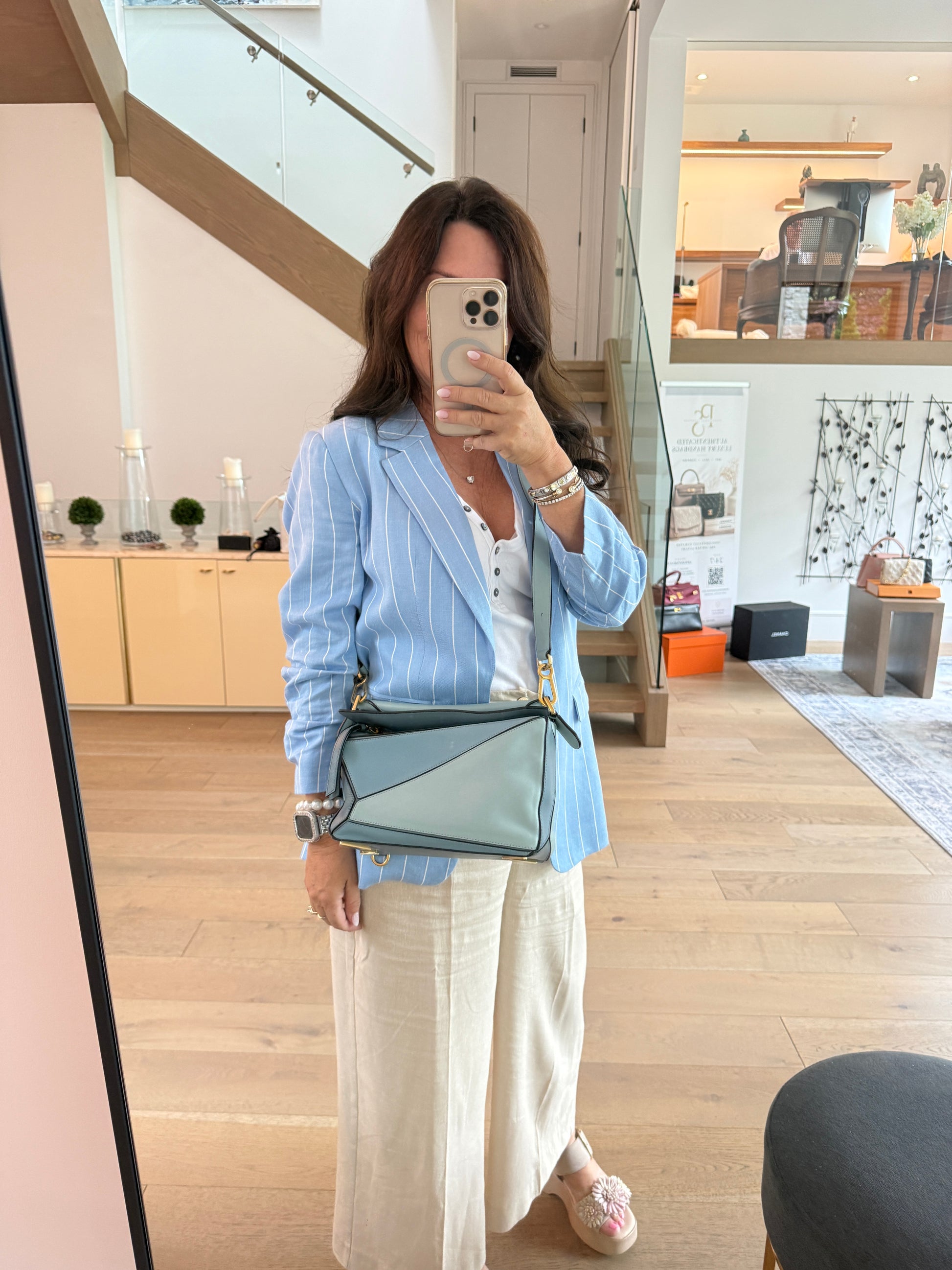 Loewe puzzle purse in blue size small shown on woman worn as a crossbody