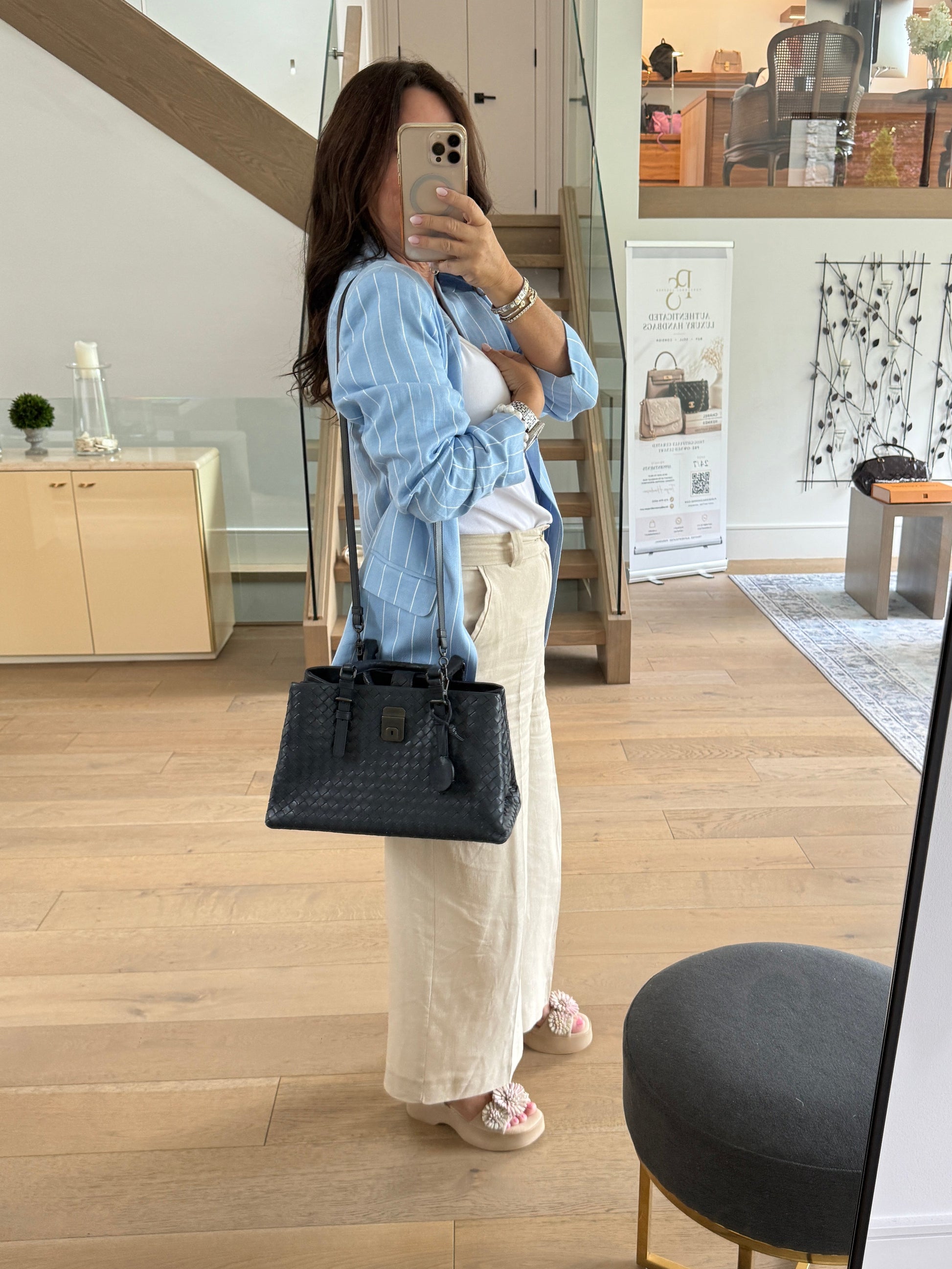 Bottega veneta Roma bag navy shown on woman as a shoulder bag
