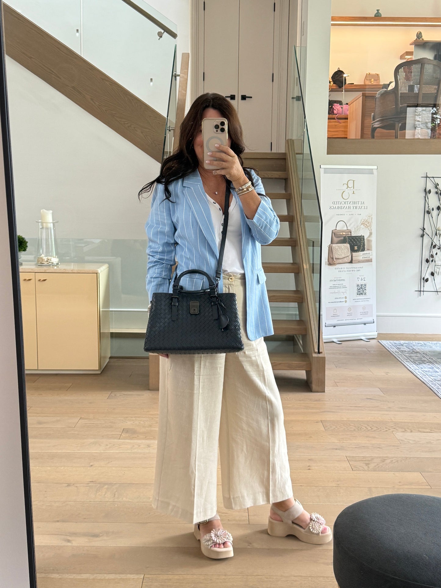 Bottega veneta navy handbag for sale shown on woman worn as a crossbody