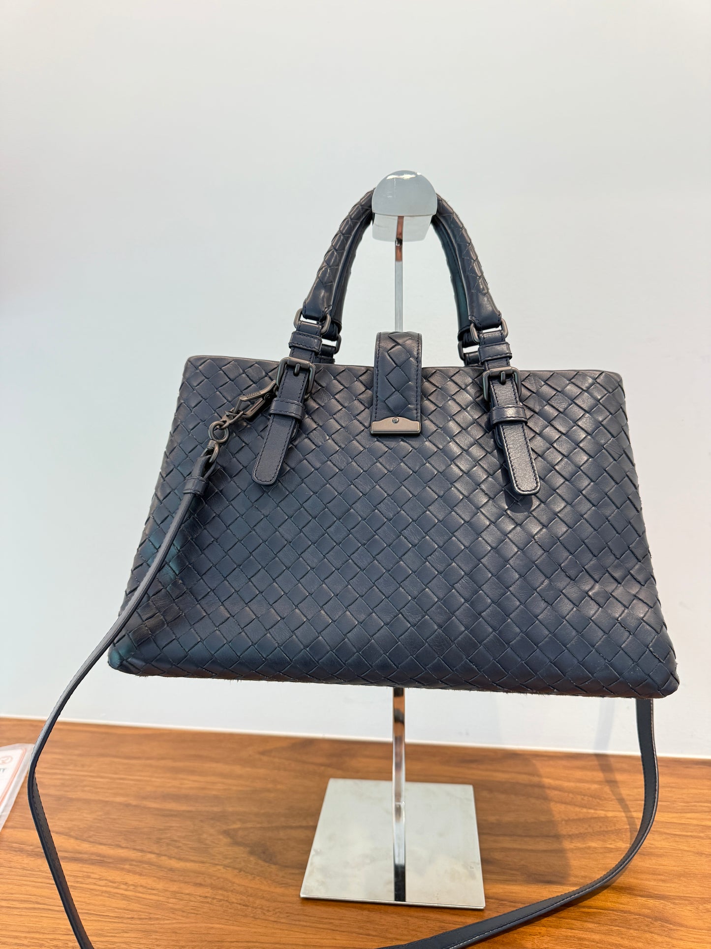 Bottega veneta navy Roma purse with top handles and shoulder strap view of the back of the purse 