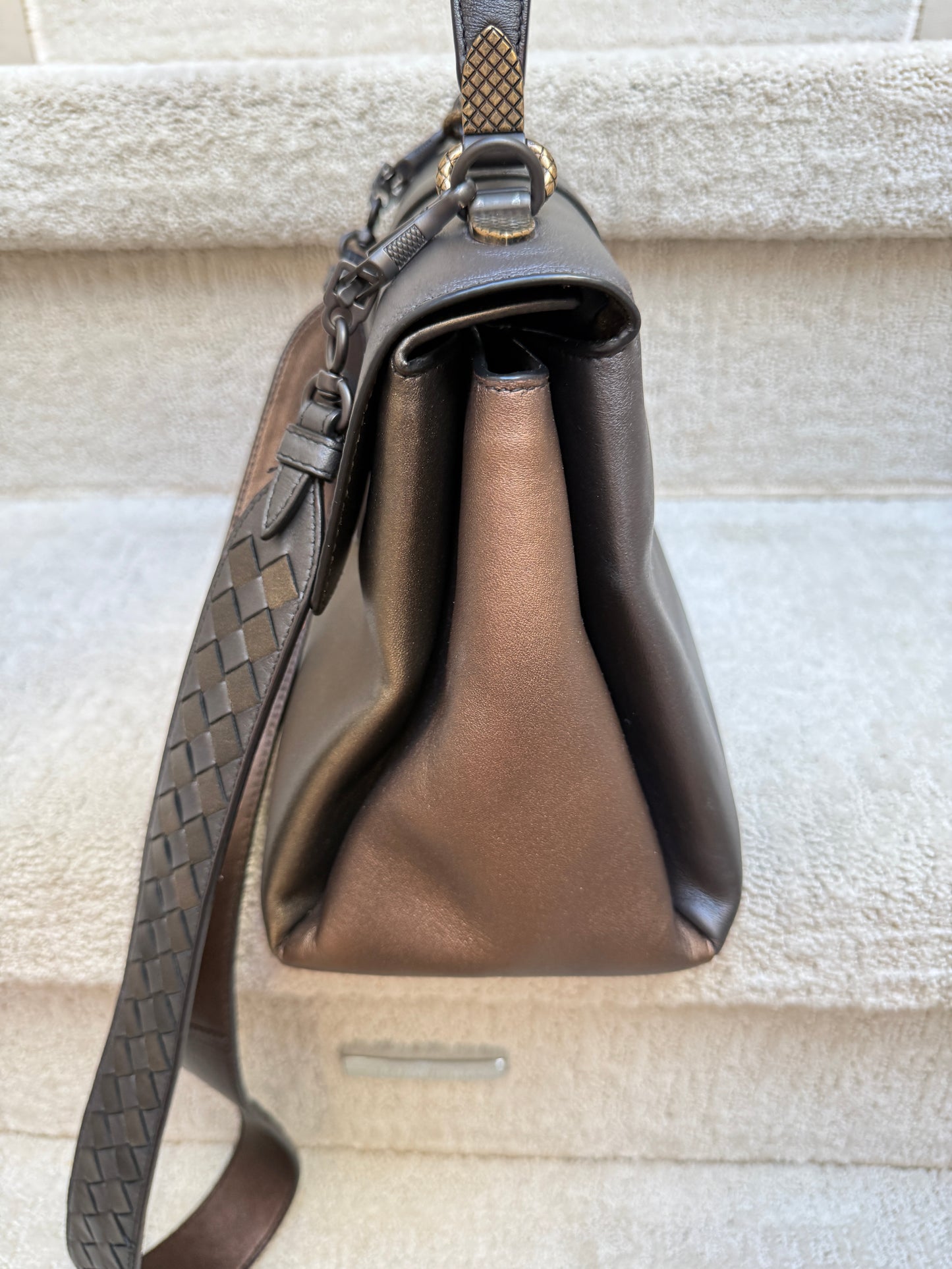 Bottega Veneta pizza side view of purse in tri color metallic bronze with woven shoulder strap