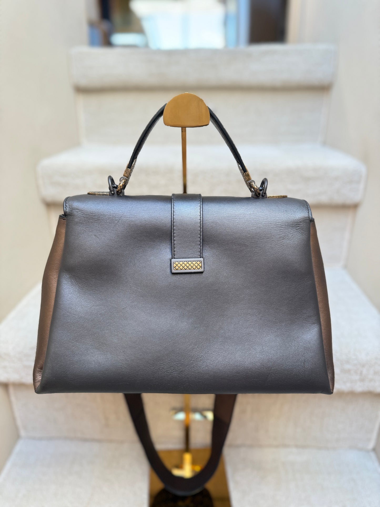 Back side of bottega veneta piazza top handle handbag in metallic calfskin