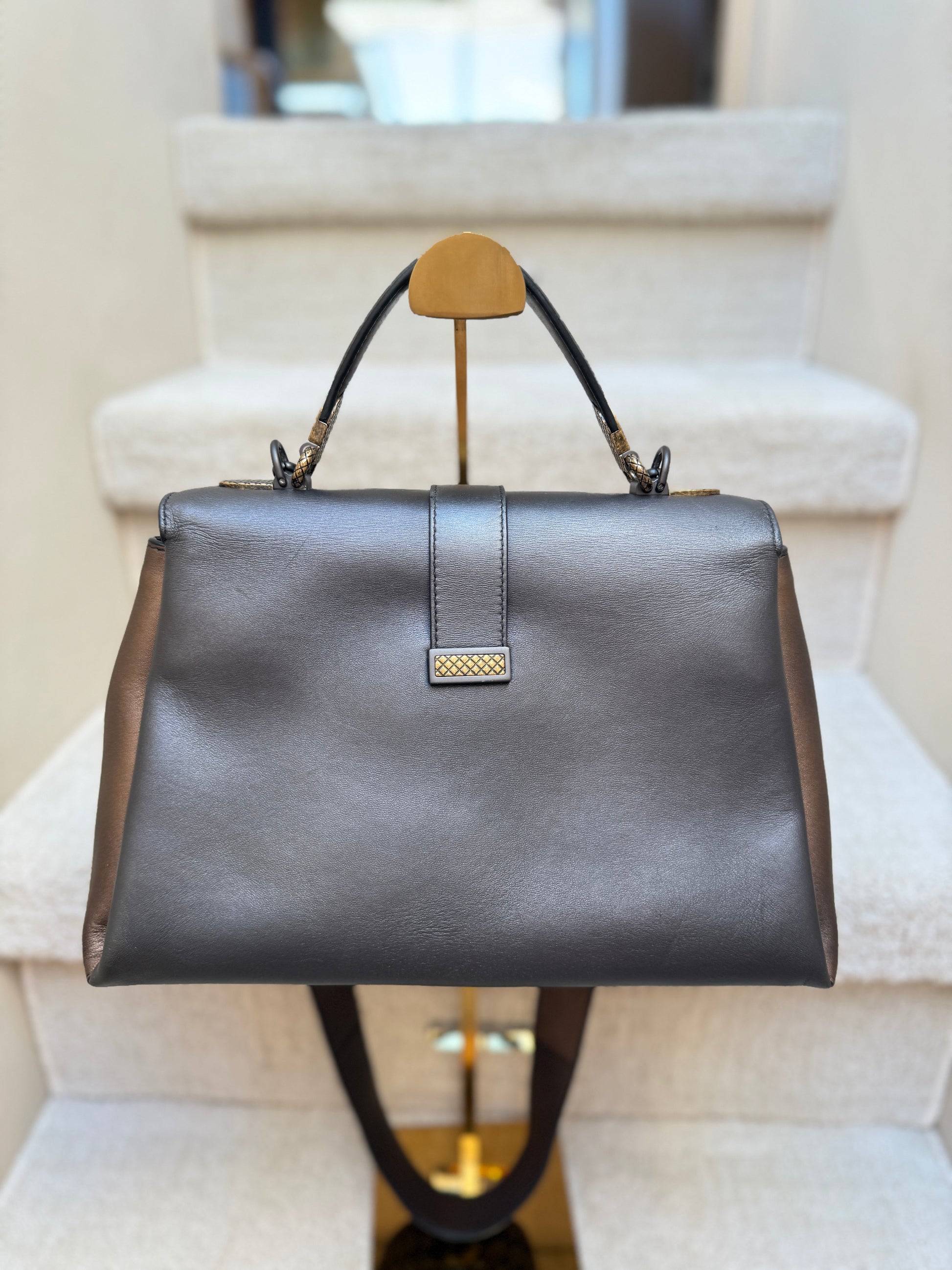 Back side of bottega veneta piazza top handle handbag in metallic calfskin