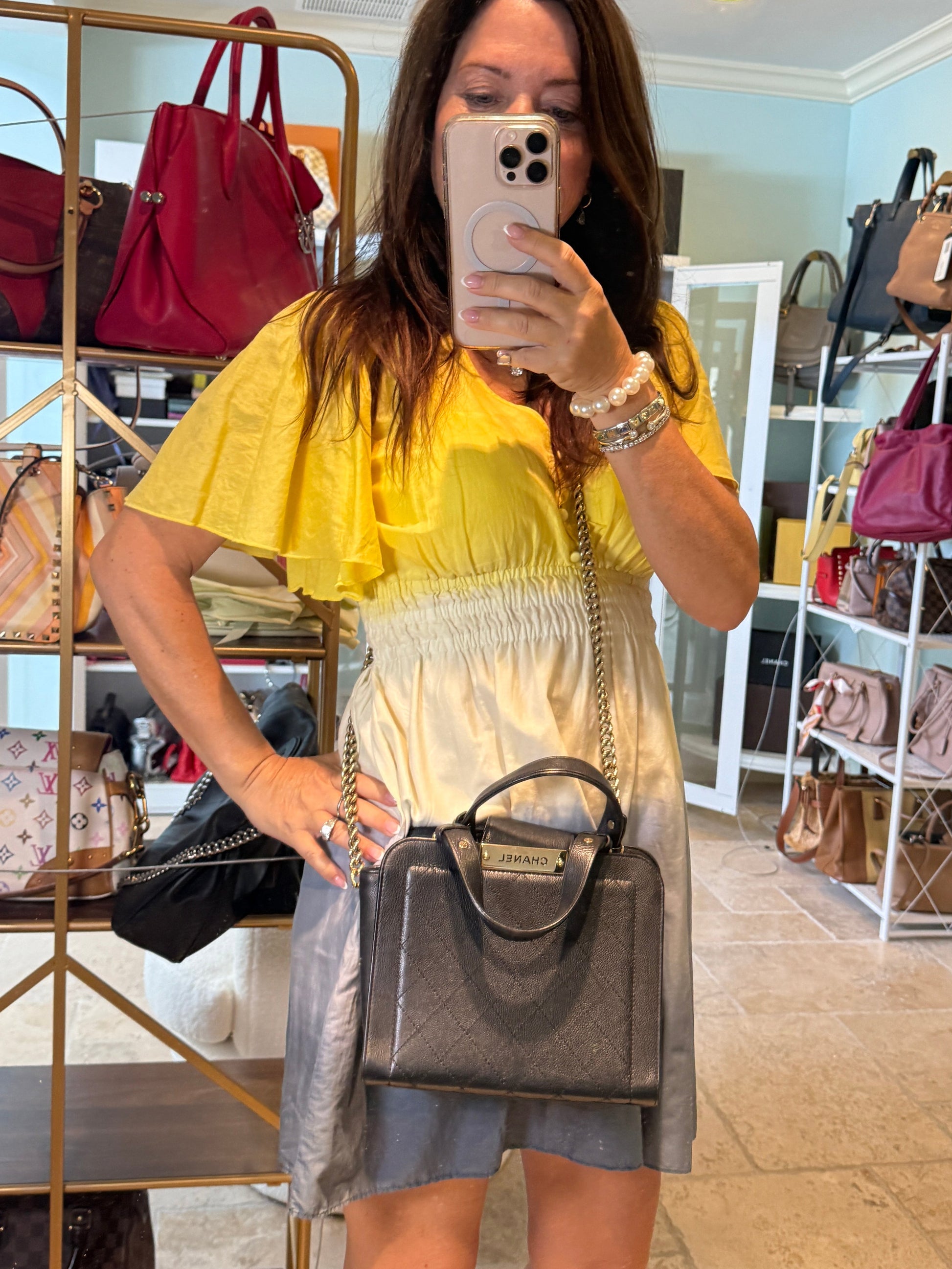 Chanel black click label handle small shown on woman worn as crossbody
