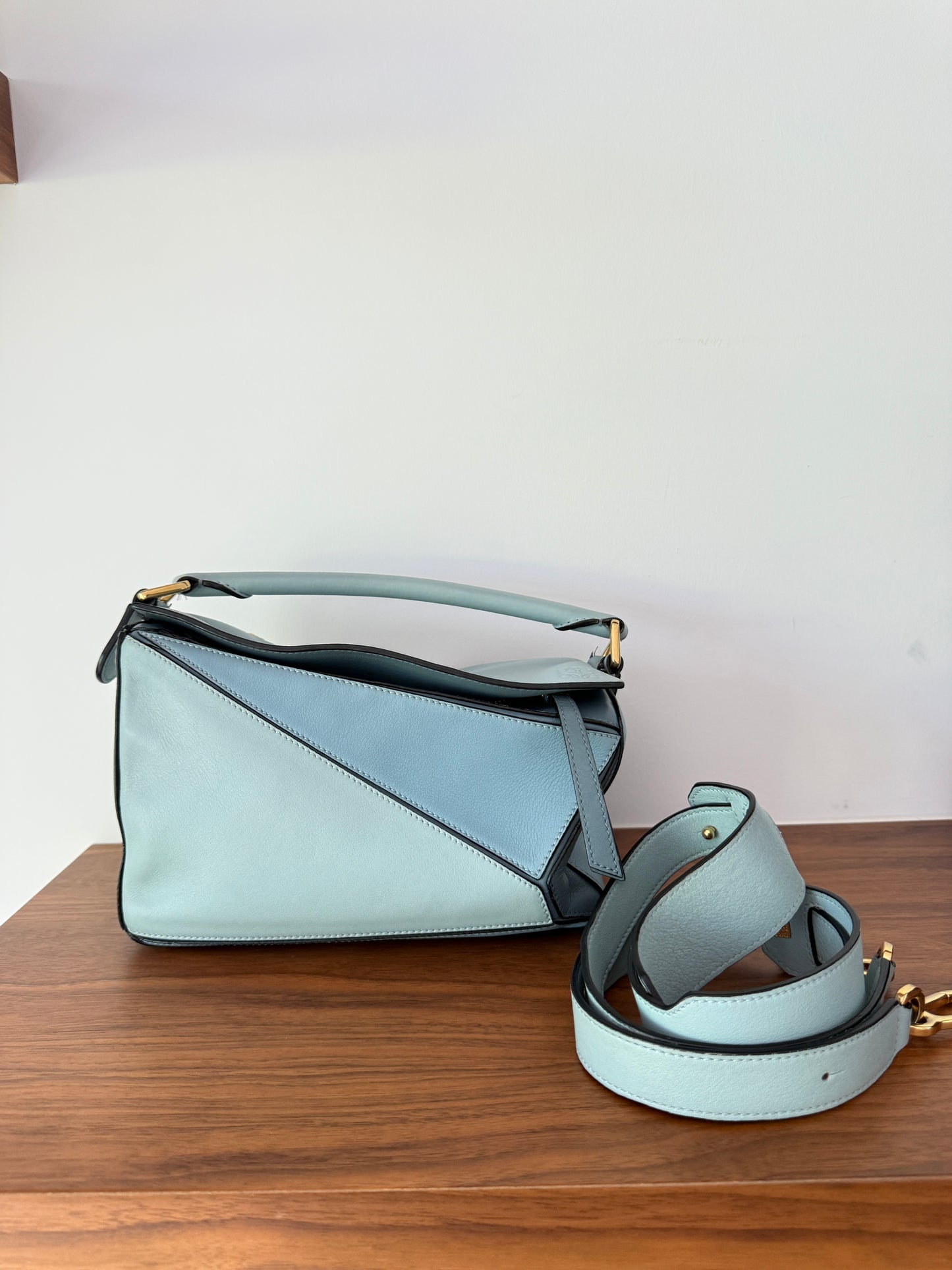 Loewe multi blue puzzle bag small shown with optional shoulder-crossbody strap for sale from Purseonalshopper 