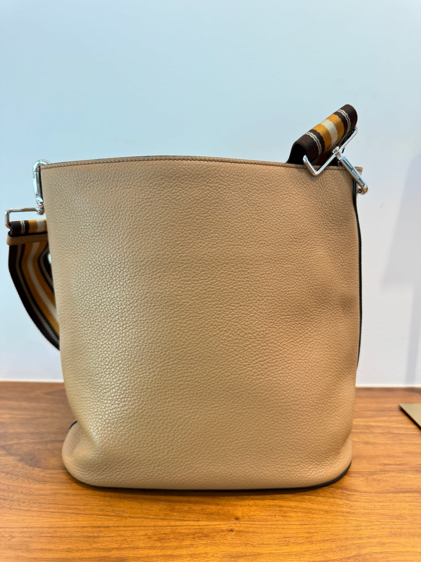 Baack side of prada bucket shaped handbag in leather used on consignment
