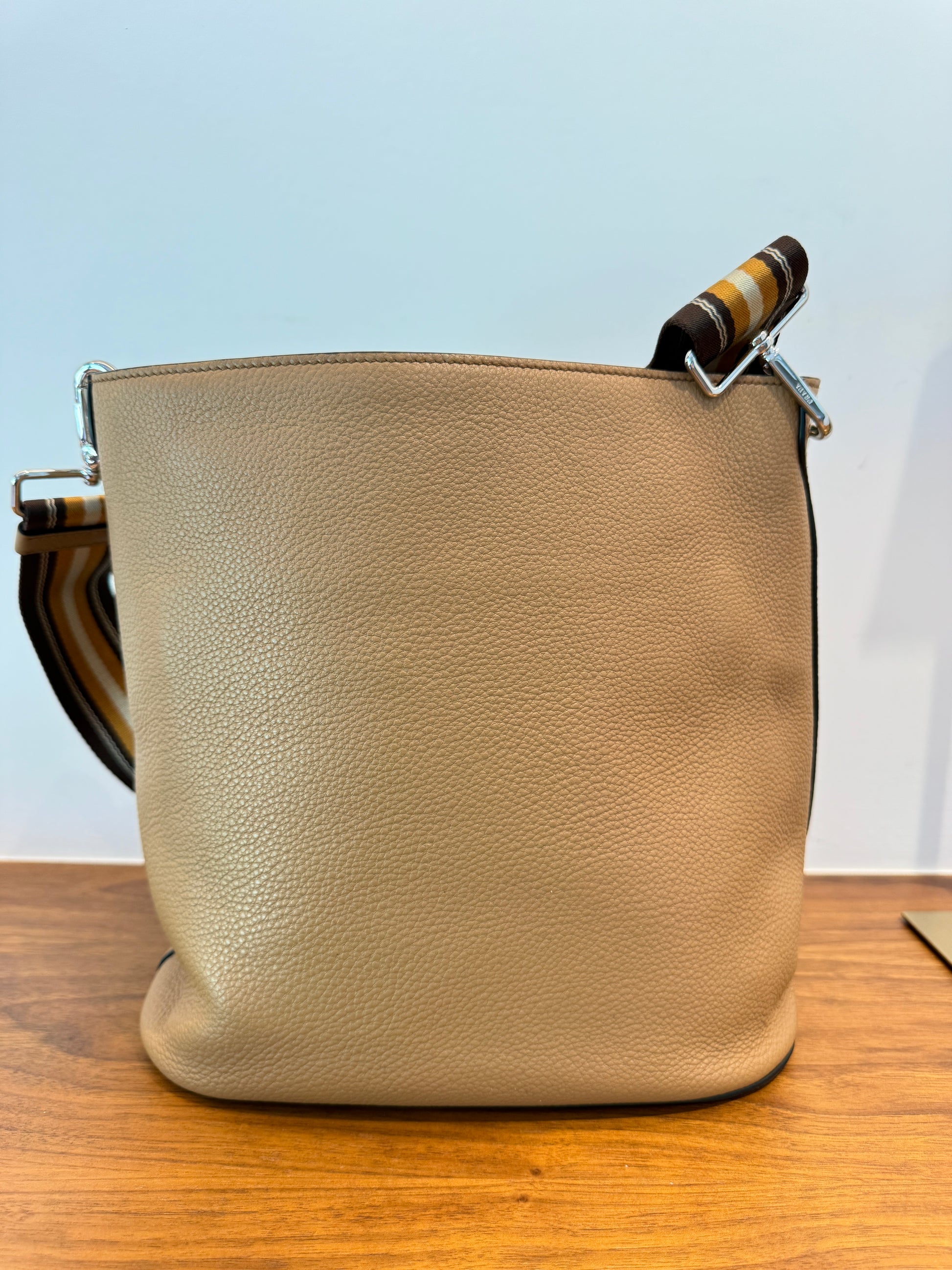 Baack side of prada bucket shaped handbag in leather used on consignment