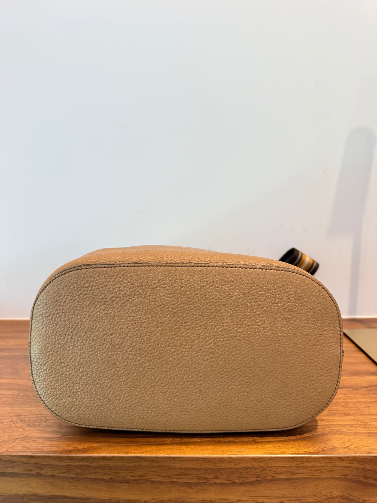 photo of bottom of prada bucket bag in camel for sale on purseonalshopper