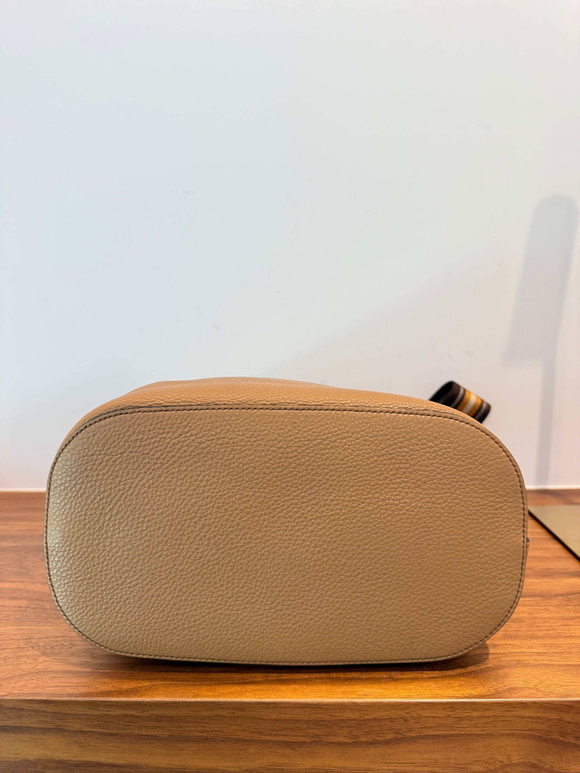 photo of bottom of prada bucket bag in camel for sale on purseonalshopper