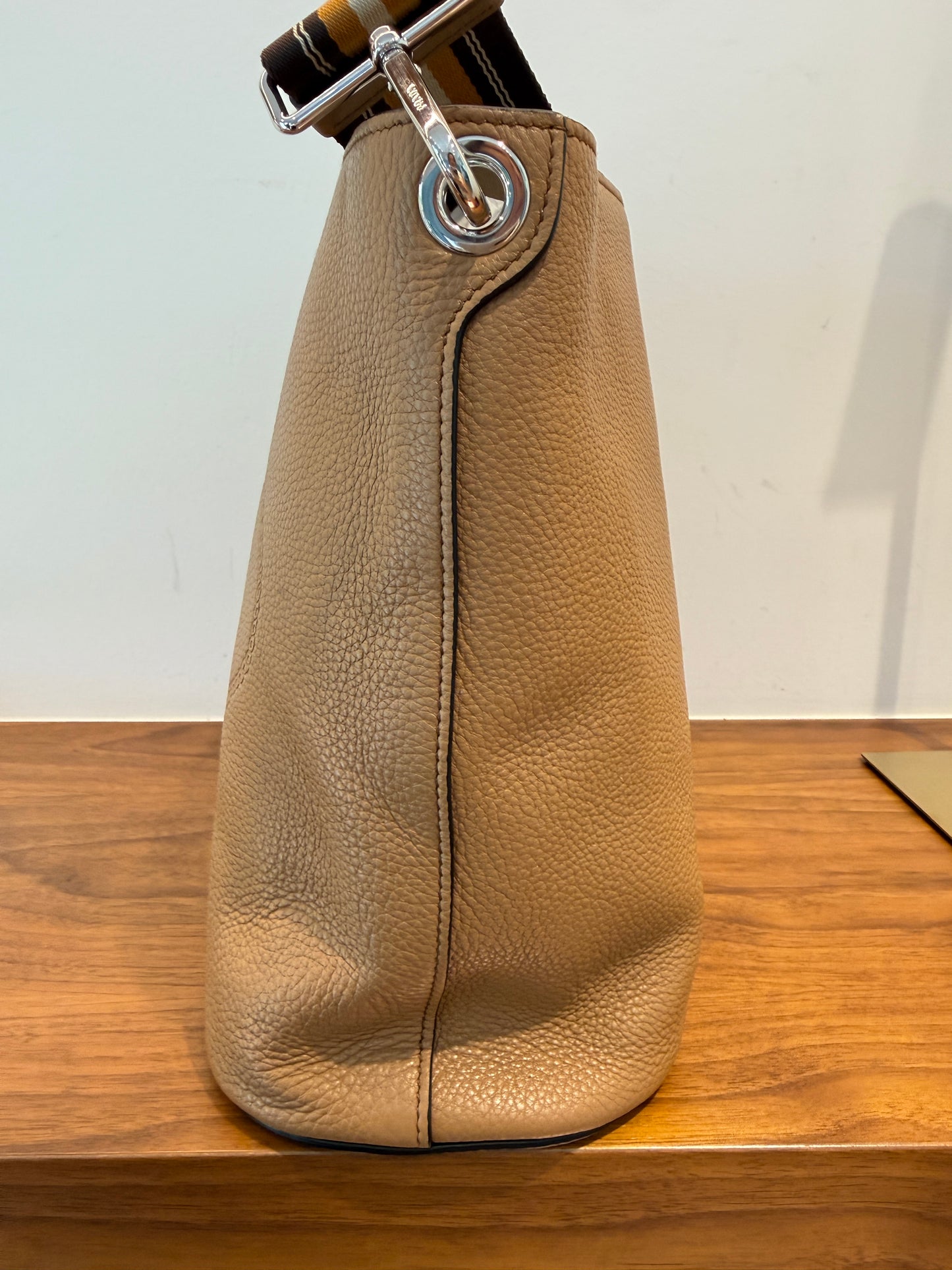 Side view of prada vitello bucket bag