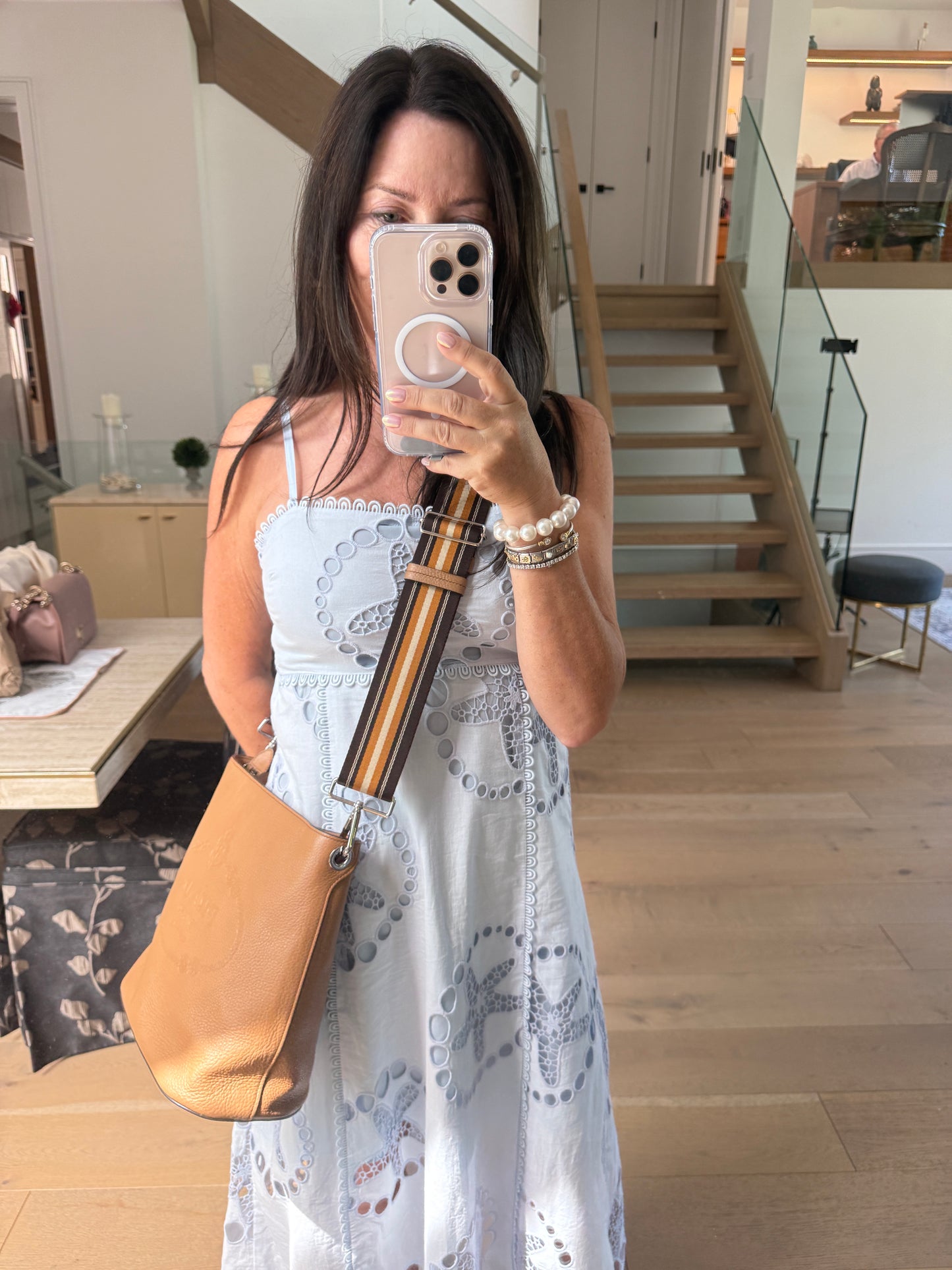 prada camel bucket bag shown on woman worn as a crossbody used and for sale