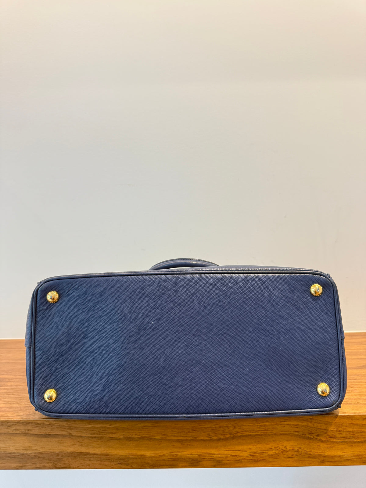 Prada galleria large in saffiano leather in navy blue with gold hardware bottom of handbag for sale shown