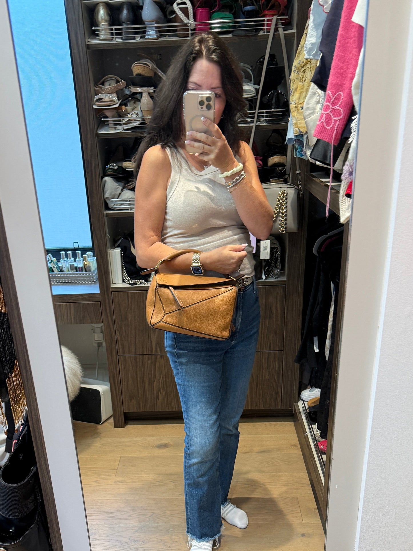 Loewe puzzle bag in camel shown carried by woman using top handle