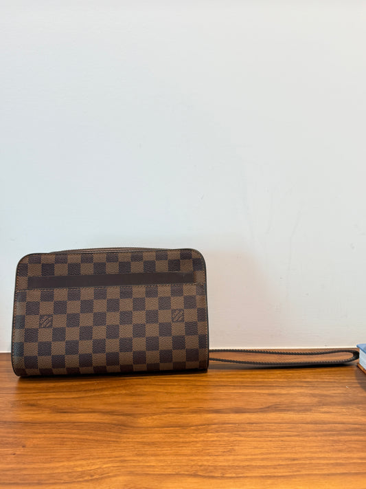A Louis Vuitton wristlet clutch in the Damier Ebene checkered canvas style authentic preowned from purseonalshopper