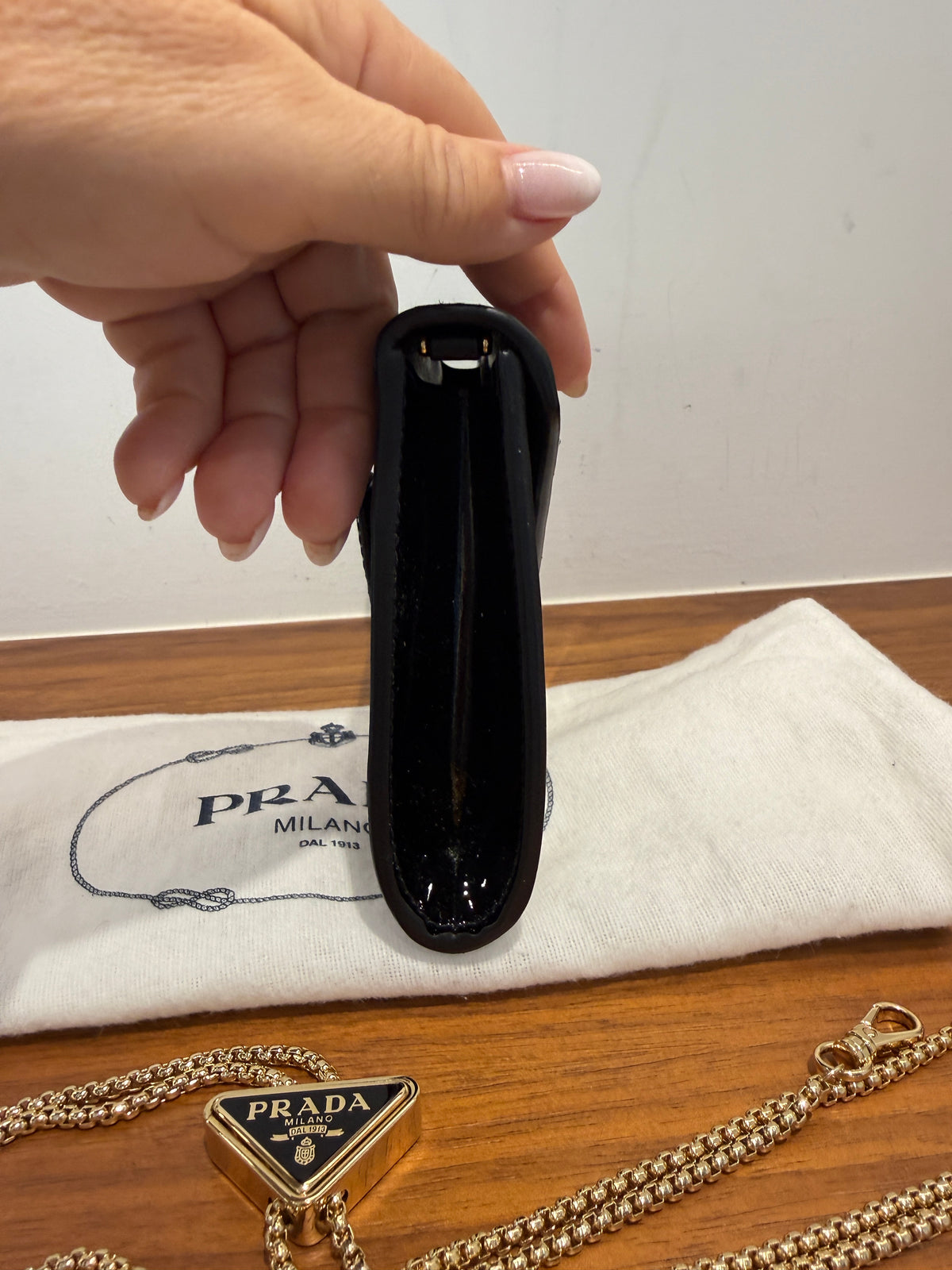 Prada Vernice Metal Triangle Logo Clutch in Black Patent Leather