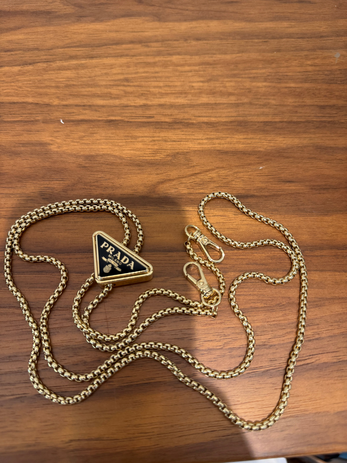 Prada Vernice Metal Triangle Logo Clutch in Black Patent Leather