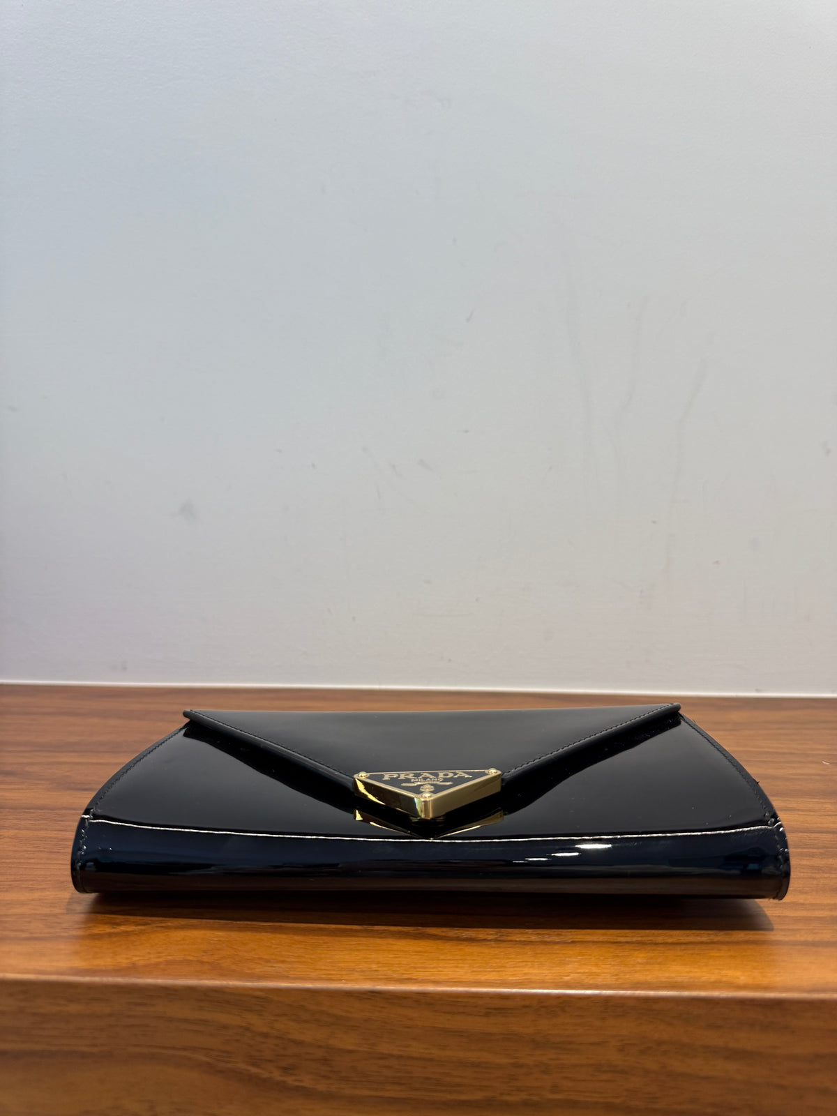 Prada clutch on chain in black patent view of bottom of handbag consignment reseller