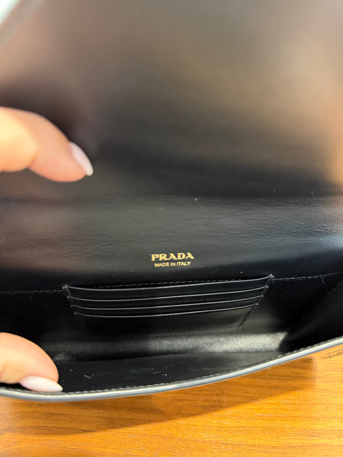 Prada black patent envelope clutch on chain interior view