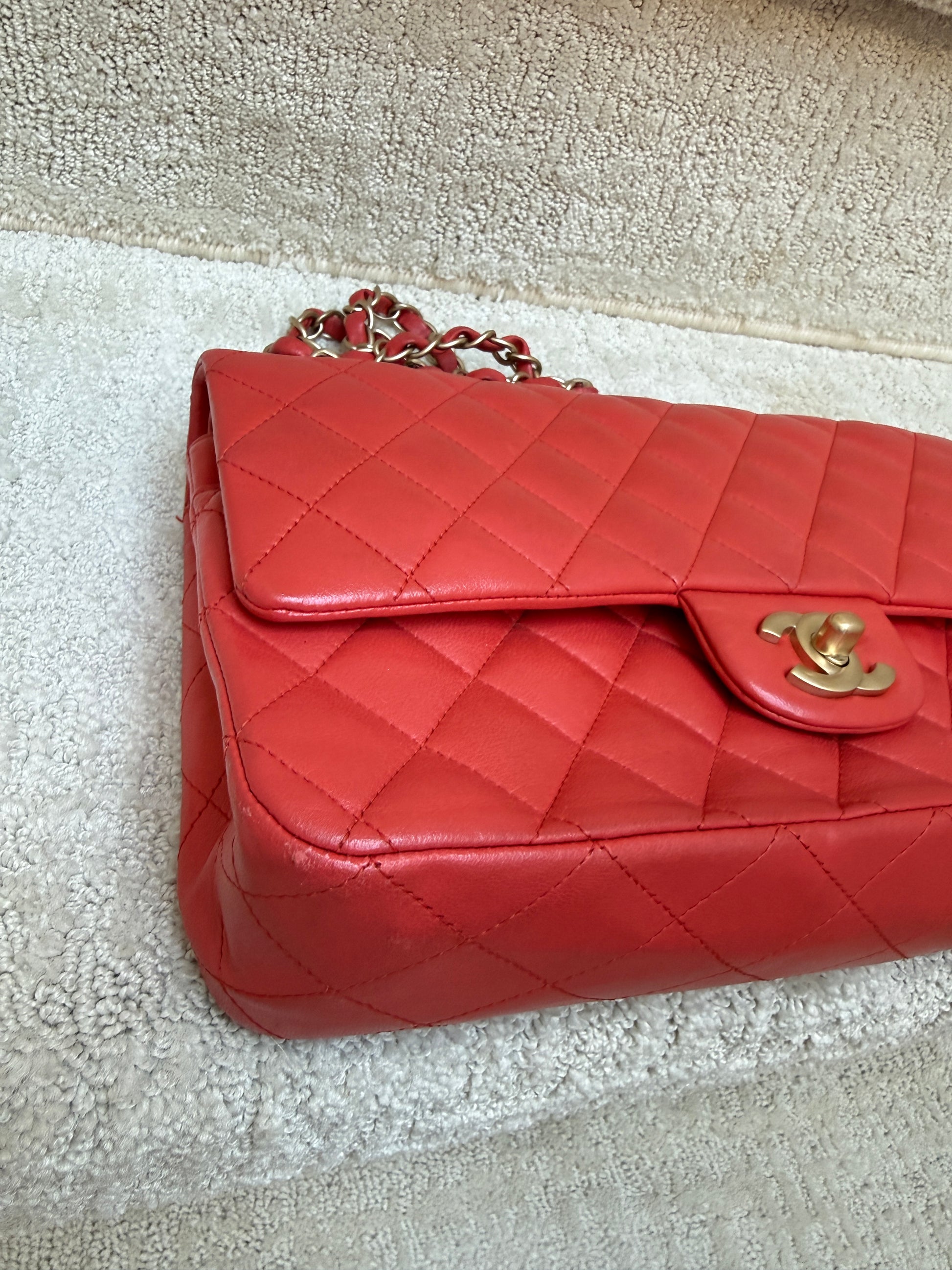 close up of front left corner of chanel classic double flap shows some wear