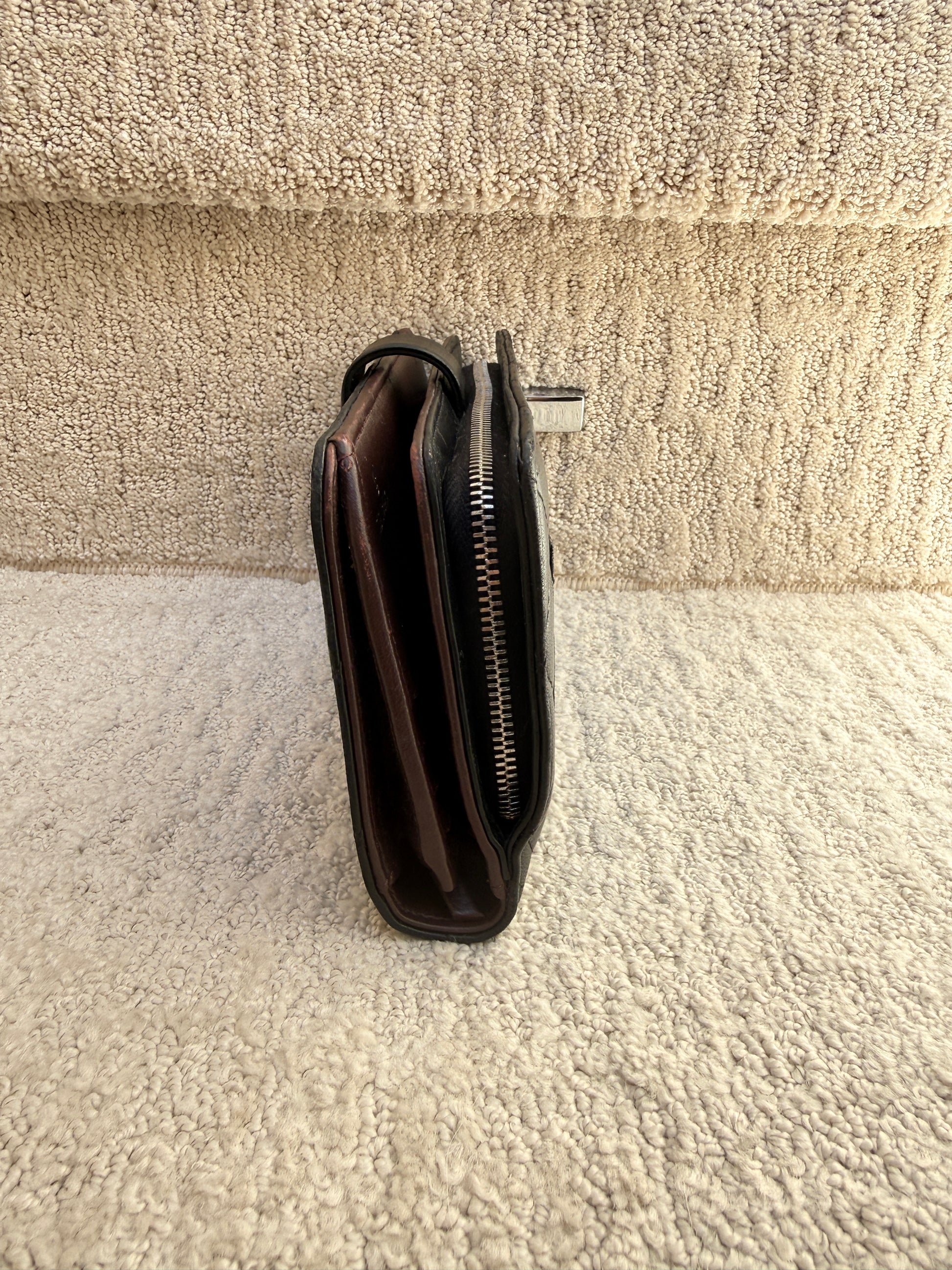 Side view of large chanel wallet with outside zipper and interior zipper and snap closure used and for sale