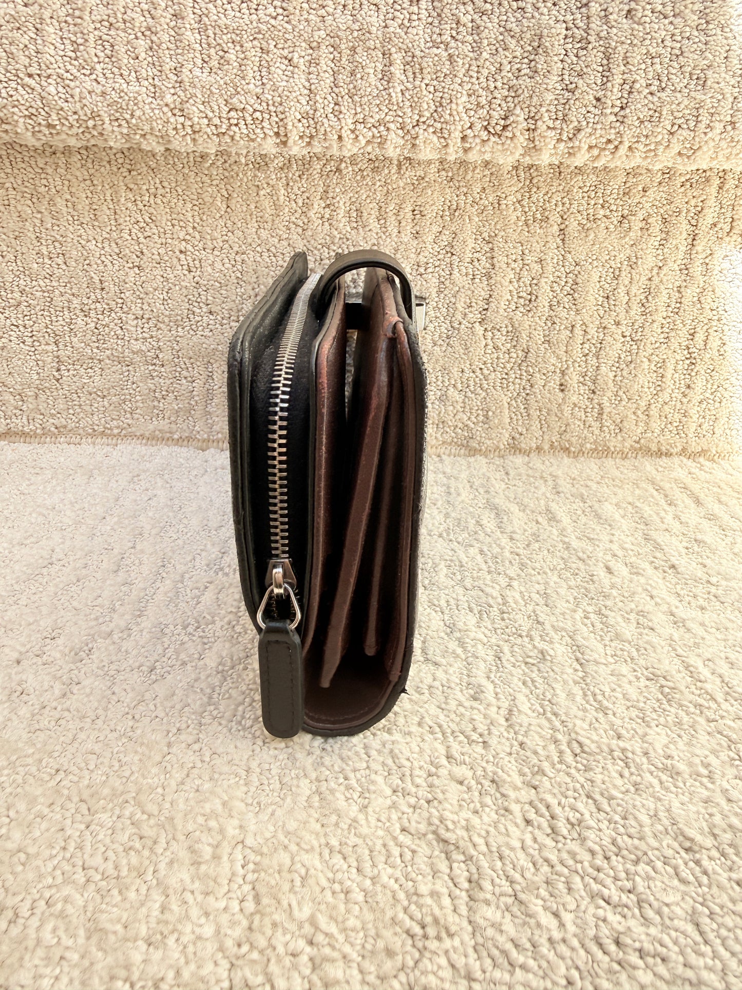 Opposite side view of leather chanel wallet large in black with burgundy leather interior