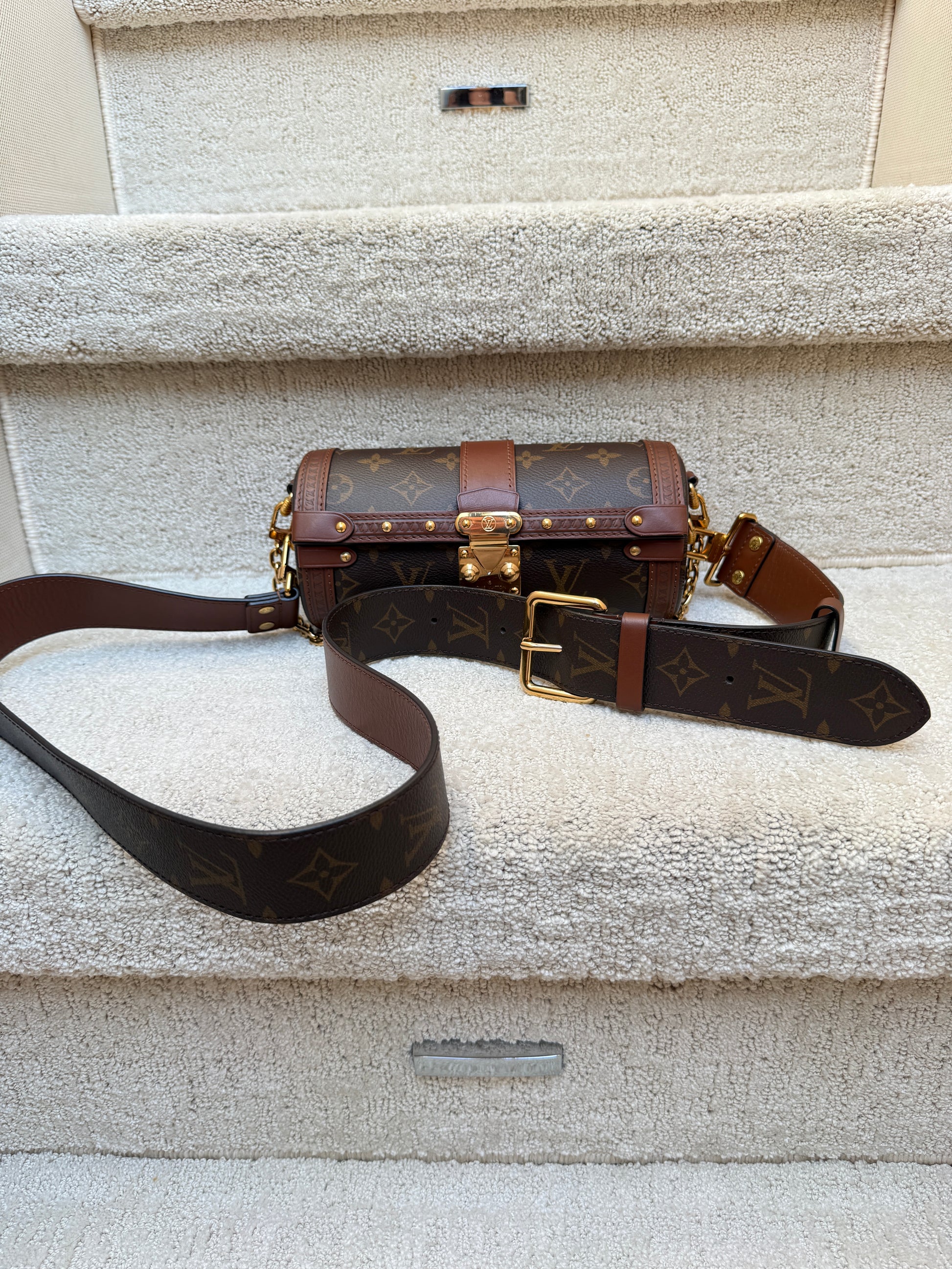 Close up of louis vuitton trunk bag cylinder with a belt strap preloved