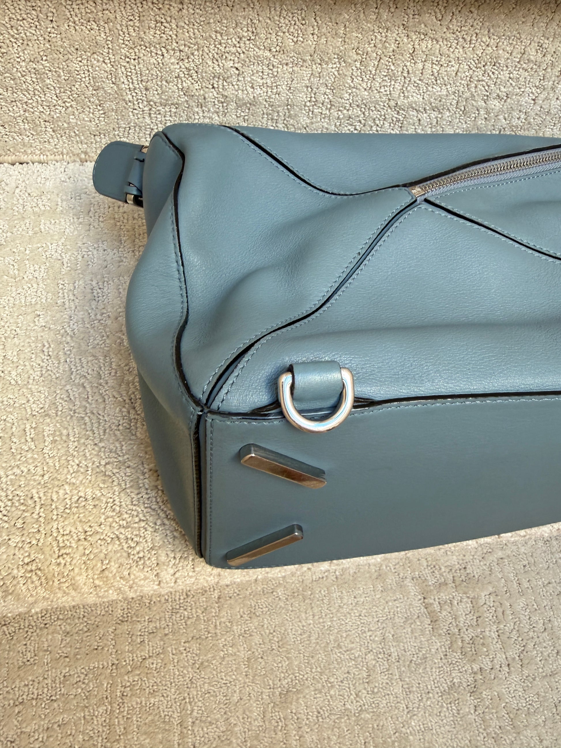 close up of loewe puzzle bag in blue leather showing clean corners used 