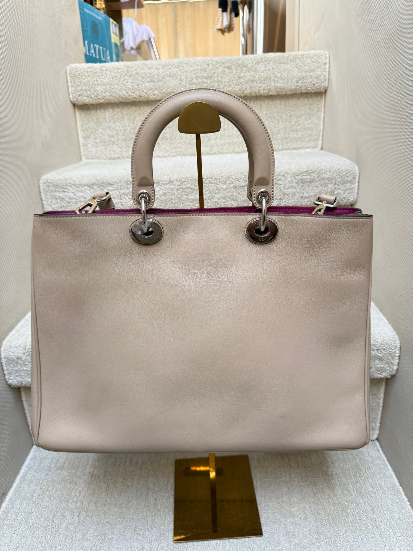 back side of dior diorissima tote beige leather with hot pink interior like new condition authentic