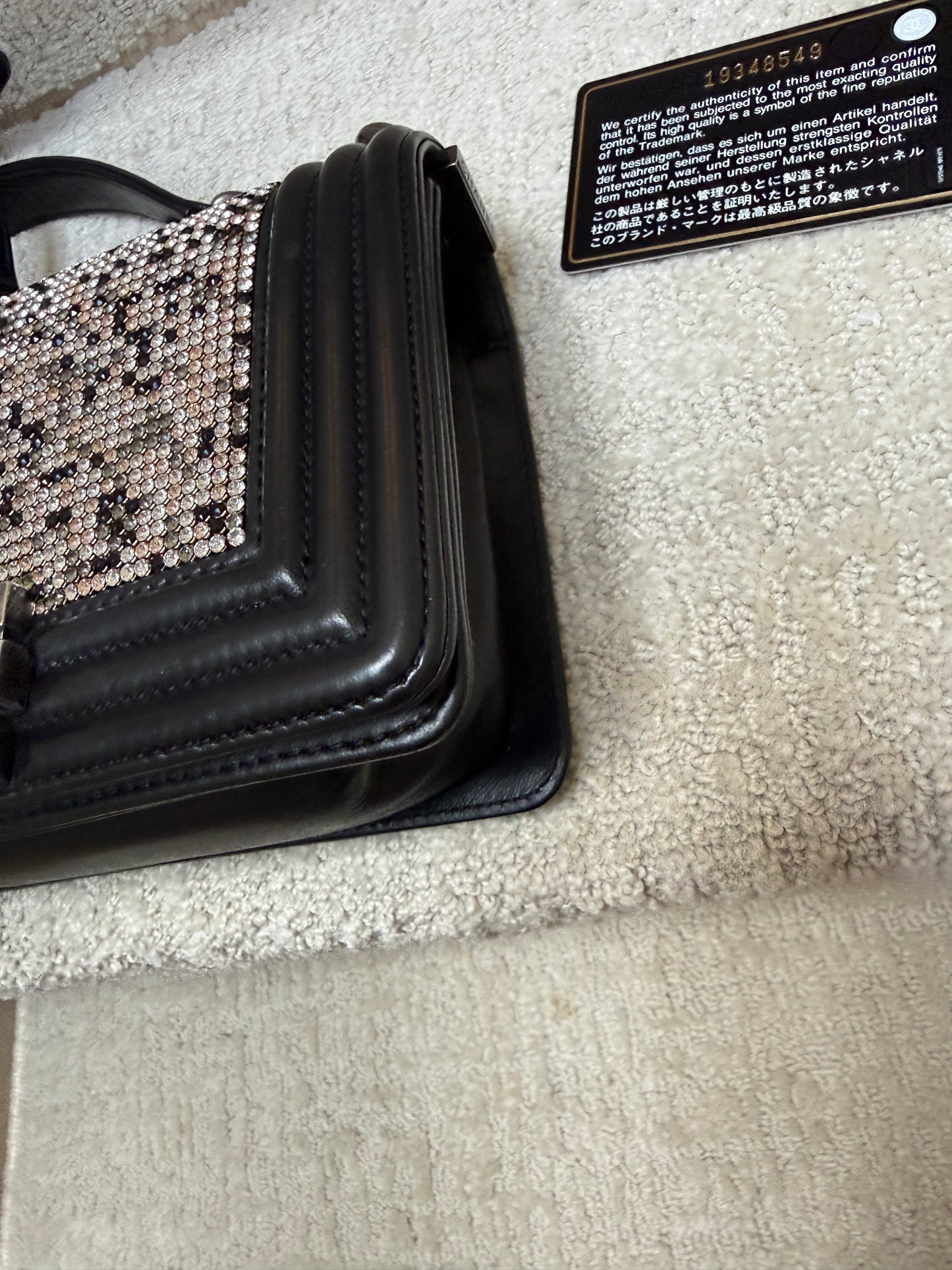 Close up of other front corner on chanel boy bag showing black card