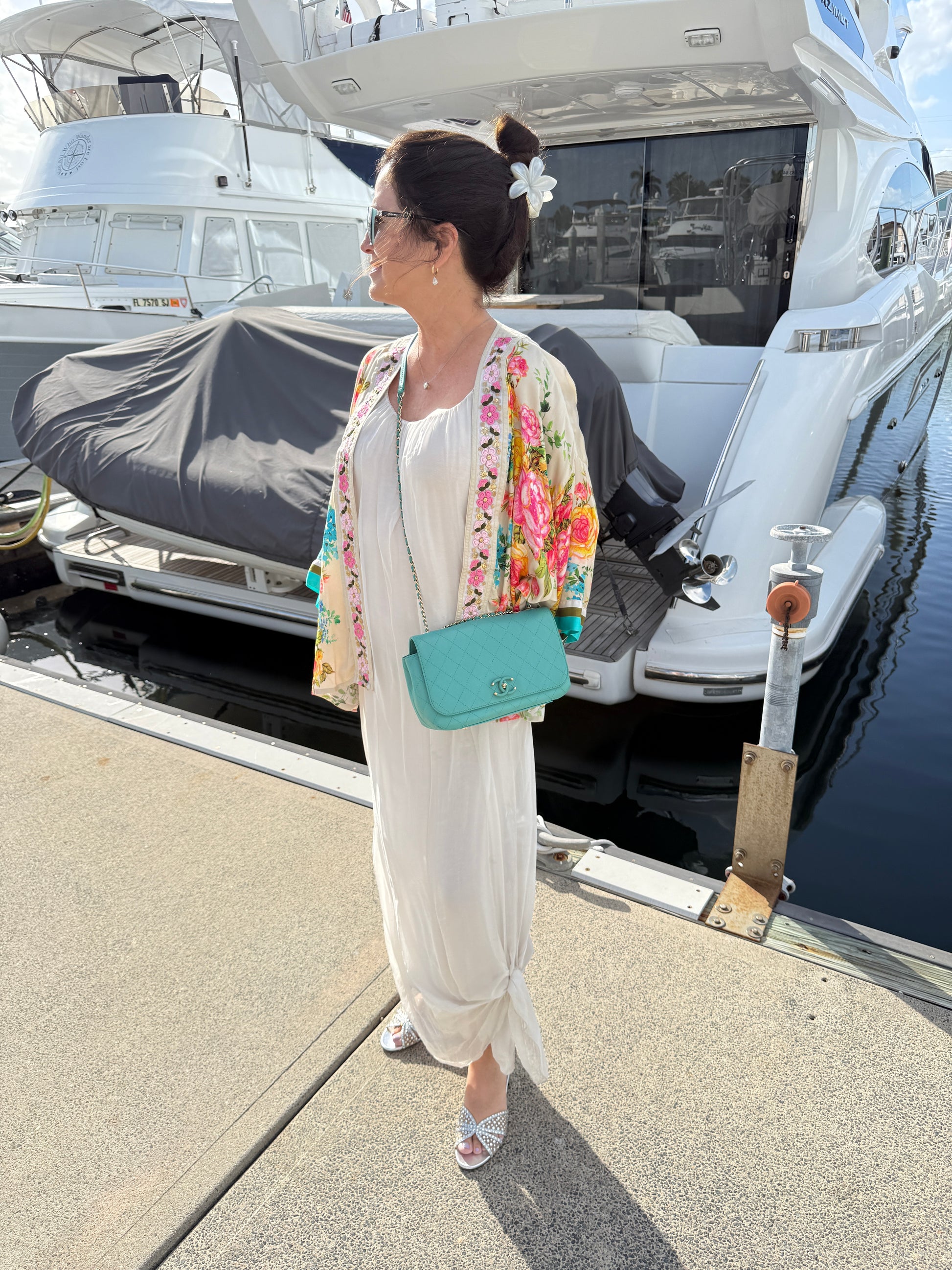 Chanel medium classic flap in turquoise shown on woman worn as a crossbody