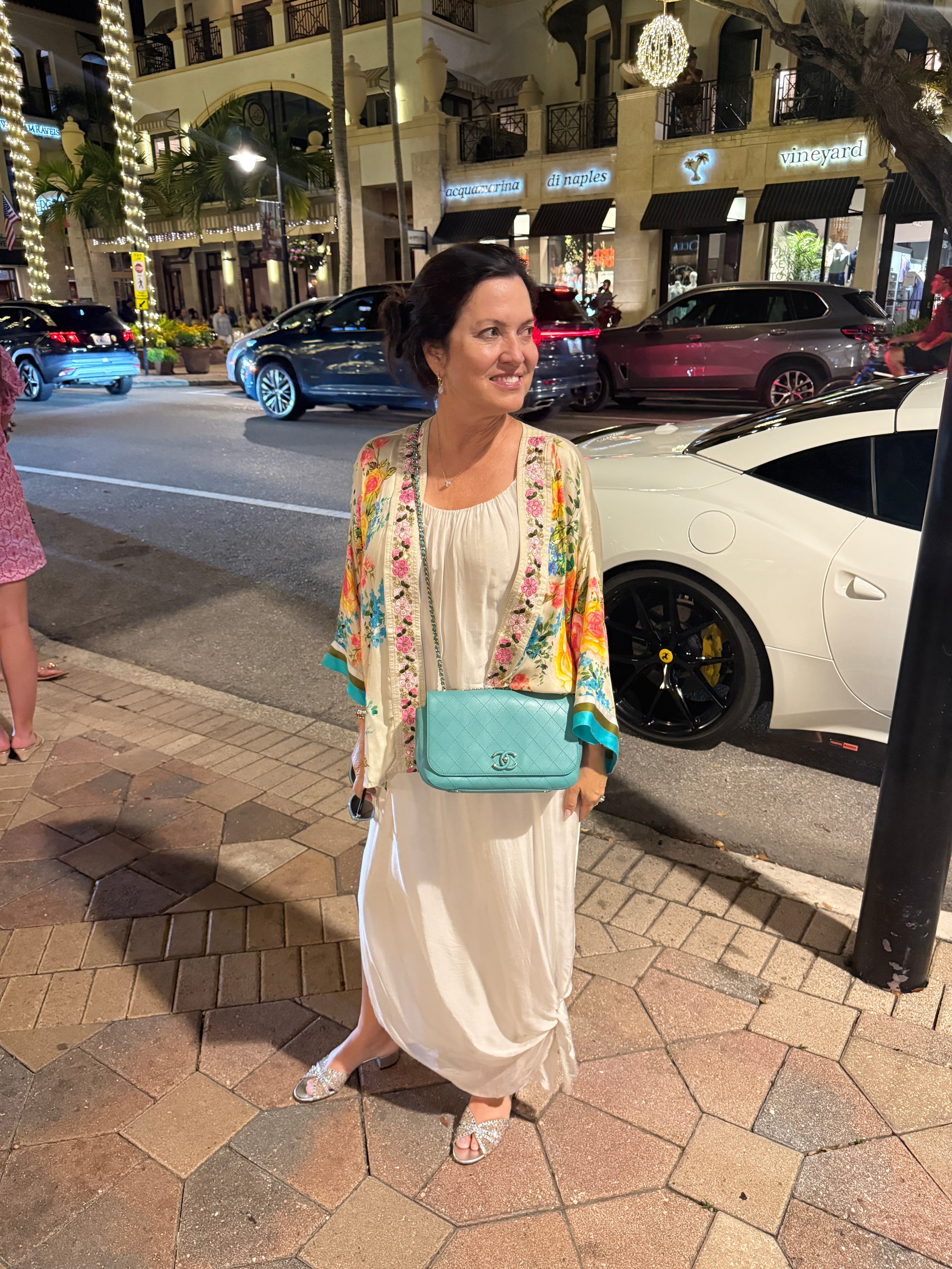 Chanel medium cc classic flap in turquoise blue shown on woman worn as a crossbody