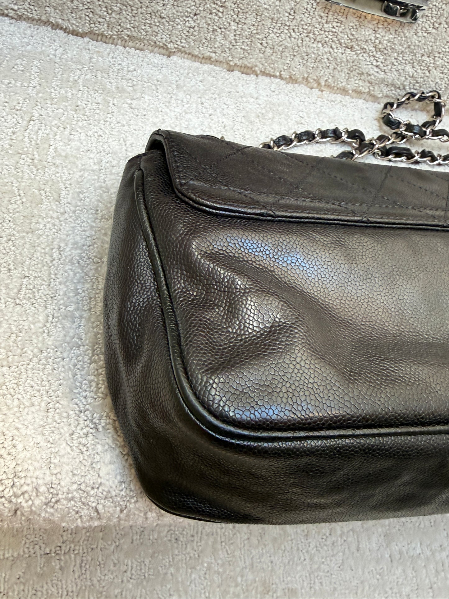 Chanel 2.55 reissue fllap in aged black caviar leather corner view
