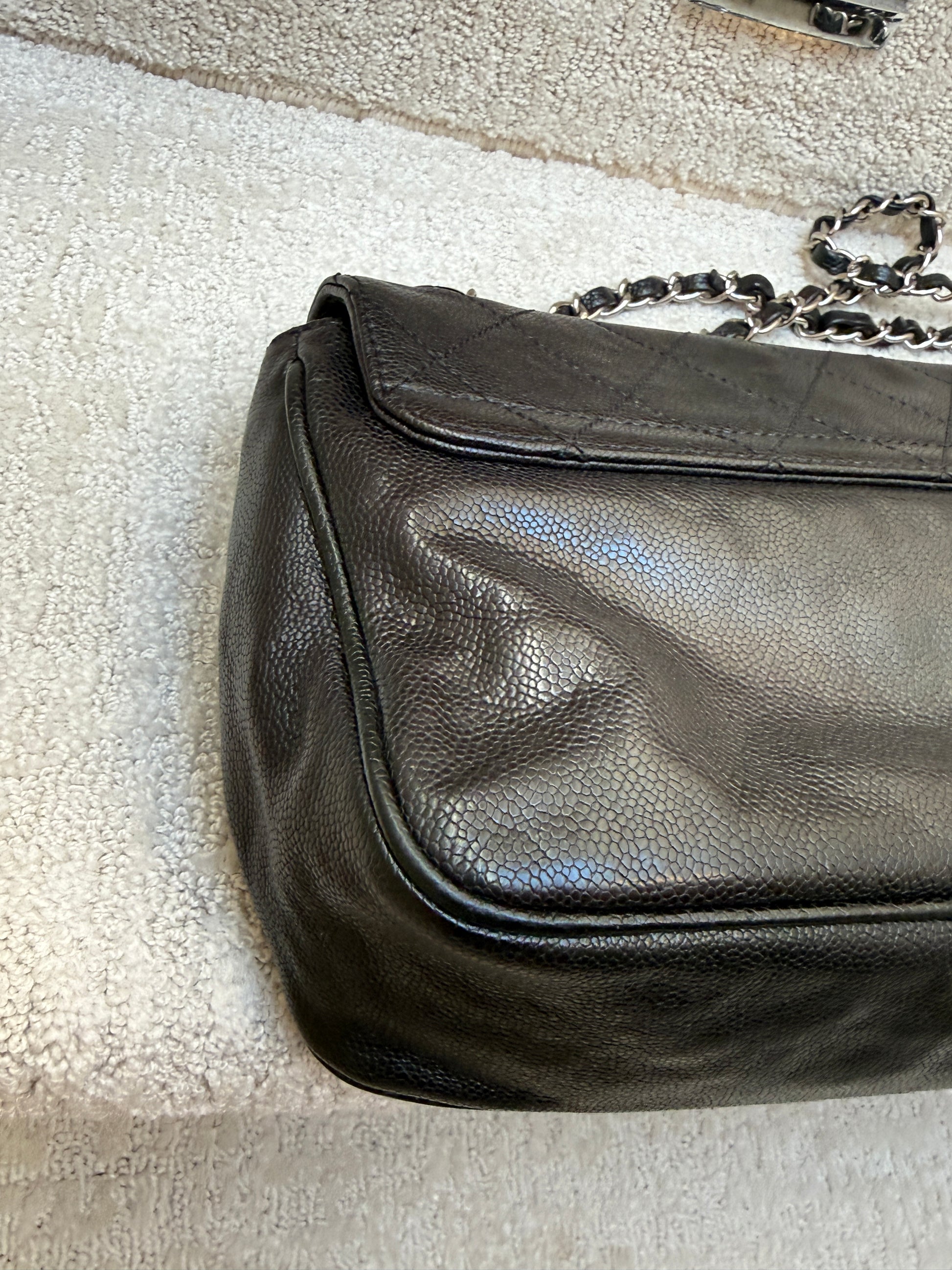 Chanel 2.55 reissue fllap in aged black caviar leather corner view