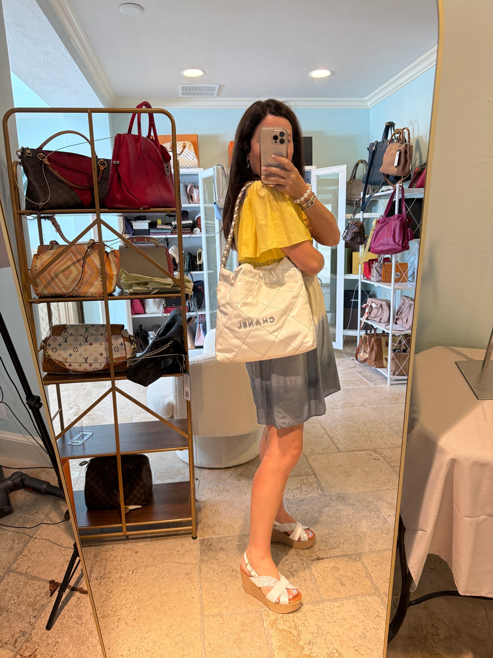 Chanel22-handbag-white-shown-carried-on-womans-shoulder