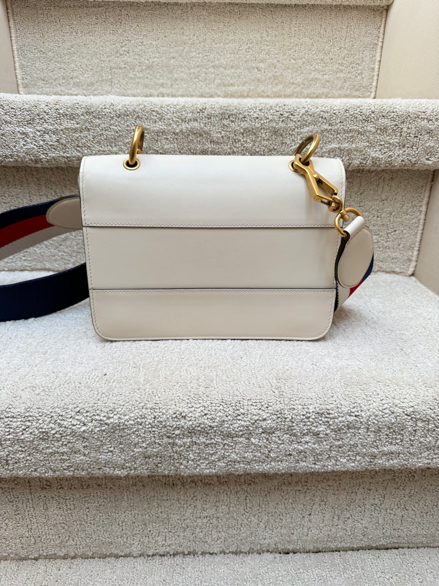 View of back of gucci queen margaret bag in white leather