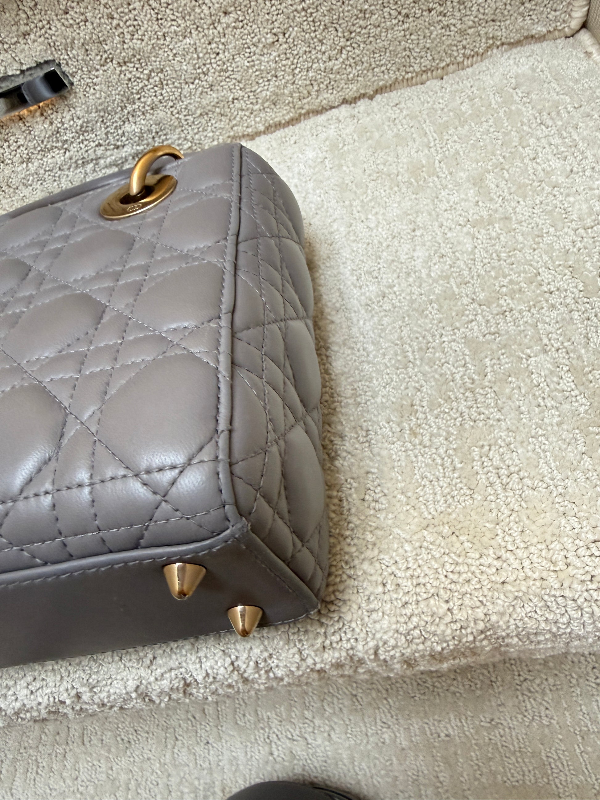 lady dior handbag close up of second corner