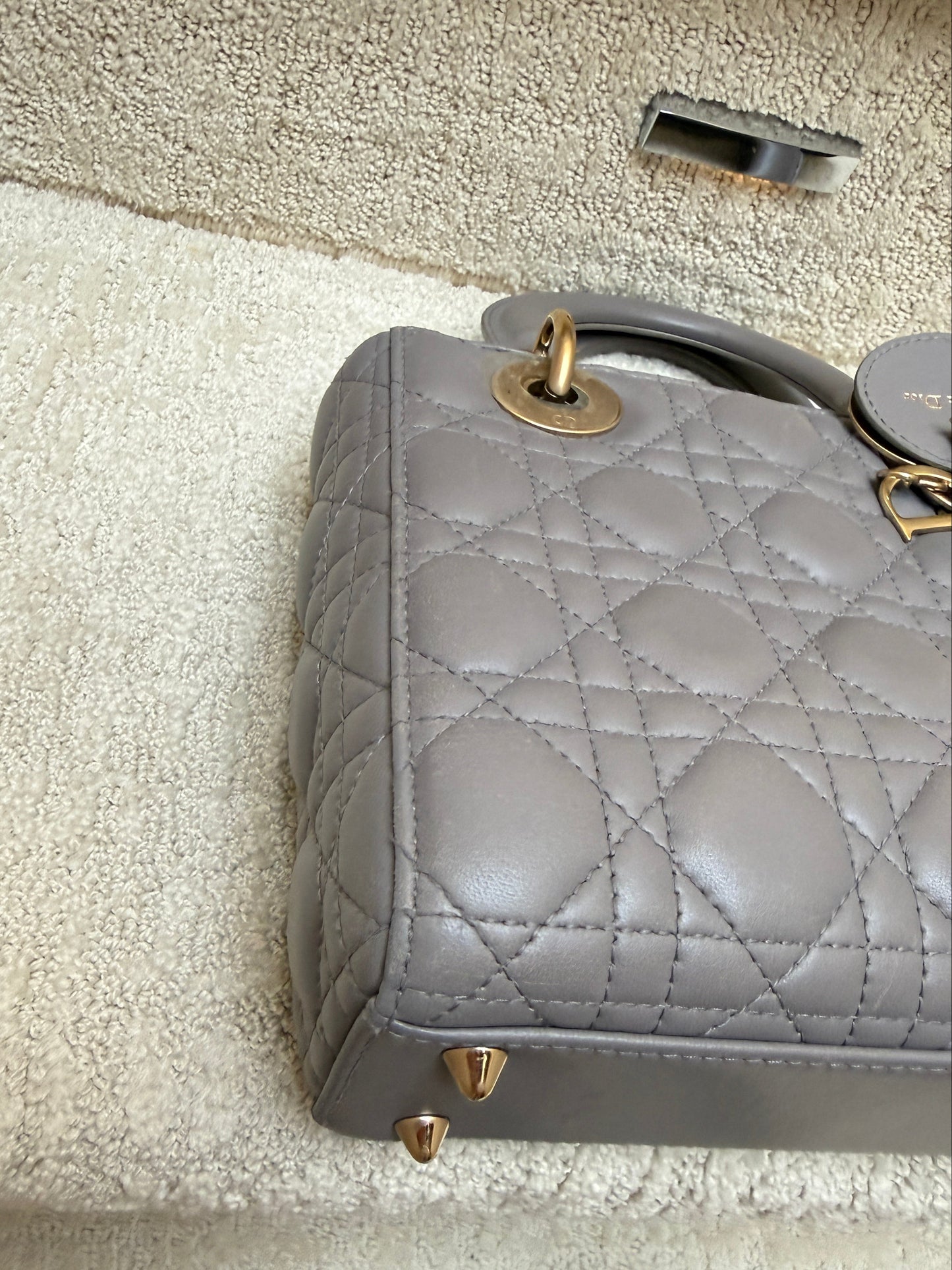 lady dior view of corner of handbag showning gold feet