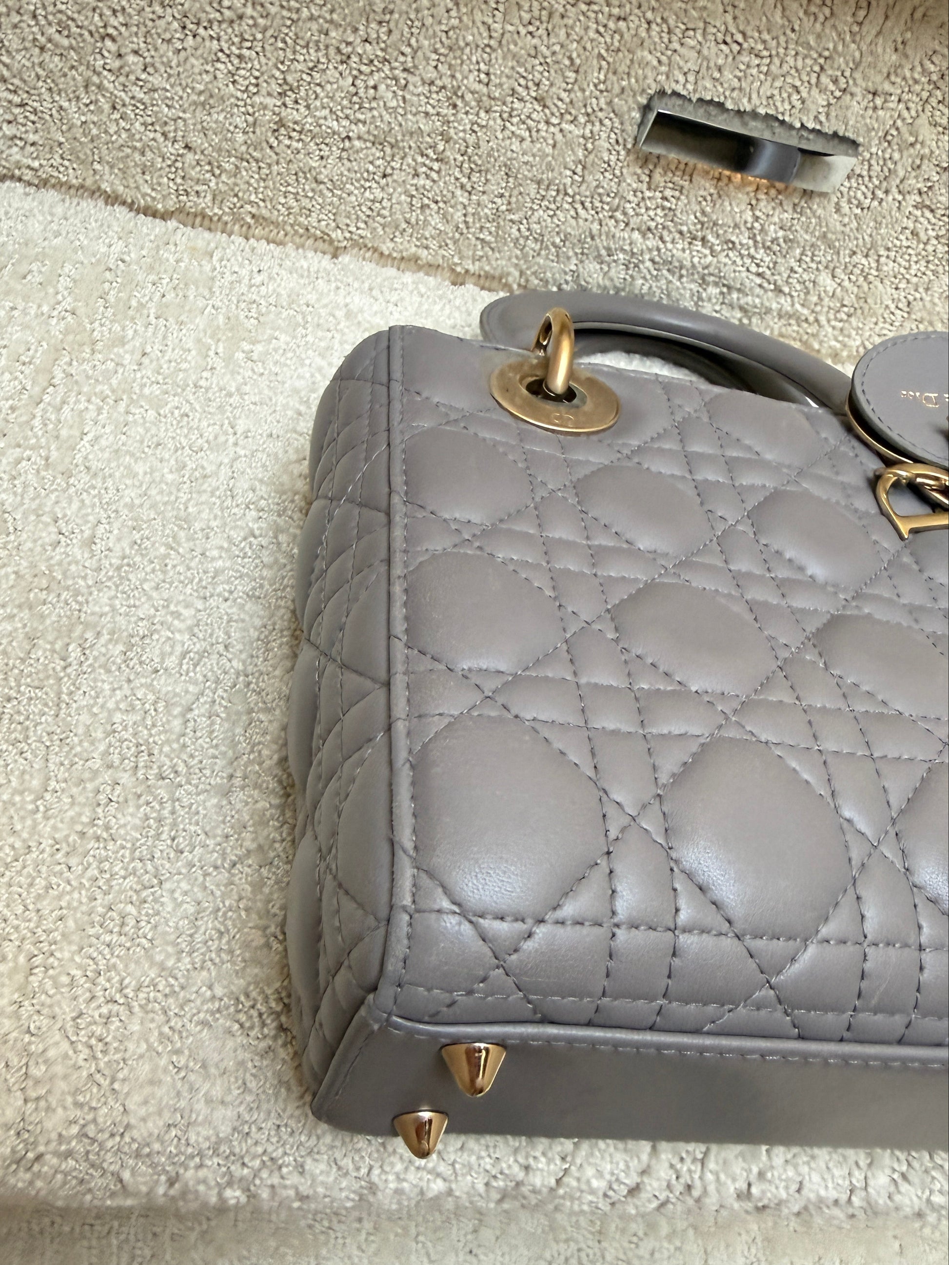 lady dior view of corner of handbag showning gold feet