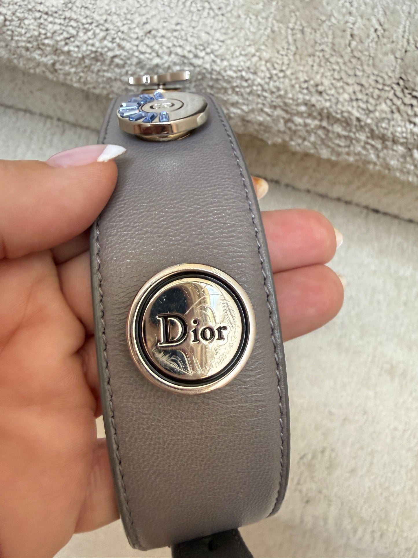 close up of thrid charm on lady dior handbag strap 