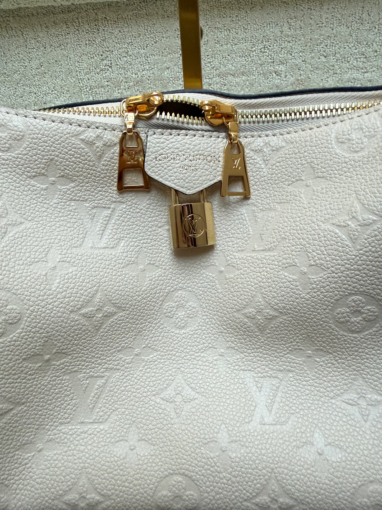 Close up of zippers and lock in gold on louis vuitton sports sac shoulder bag from purseonalshopper