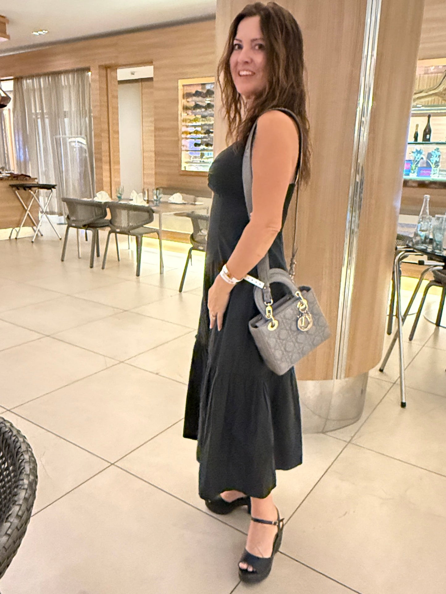 Christian dior lady dior small bag in grey shown on womans shoulder