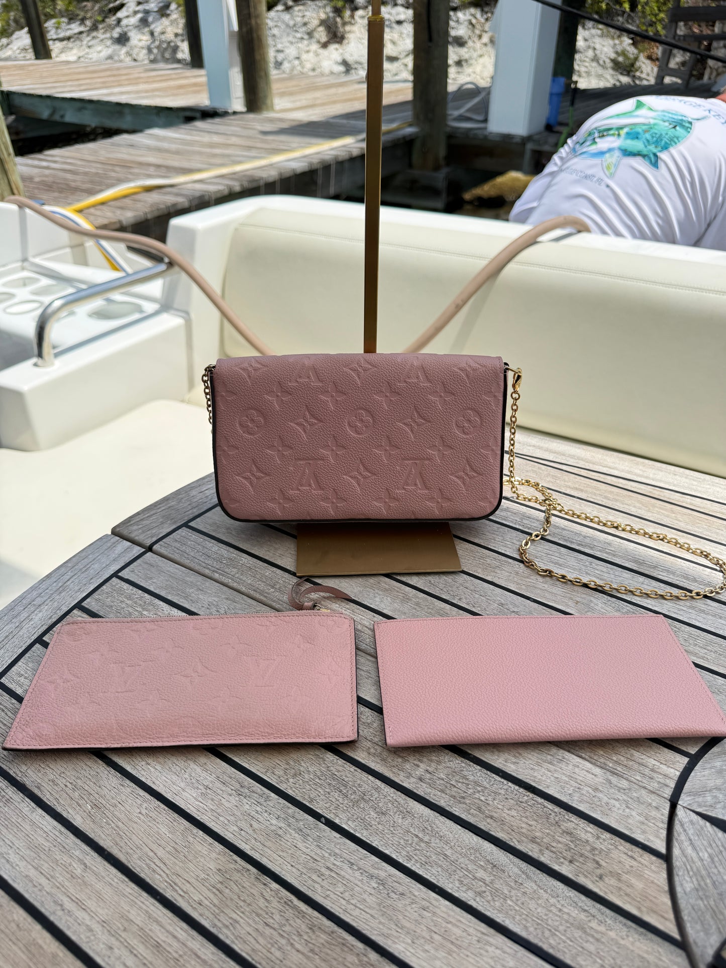 louis vuitton fellicie pochette empreinte pink embossed view of back of handbag