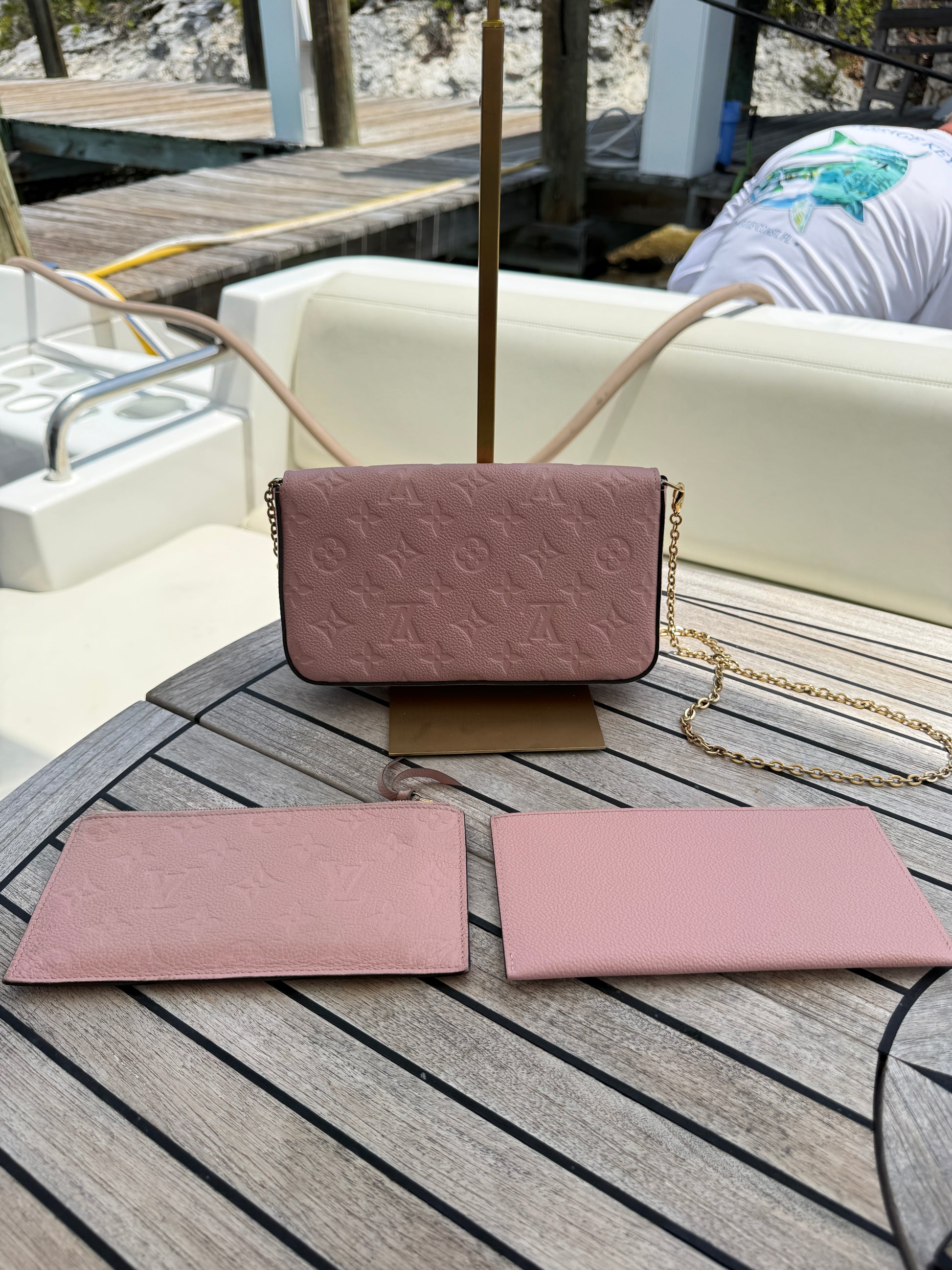 louis vuitton fellicie pochette empreinte pink embossed view of back of handbag