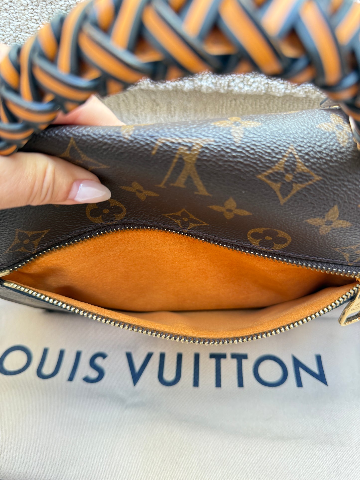 close up of back zipper pocket on louis vuitton metis pochette in monogram used and in like new condition