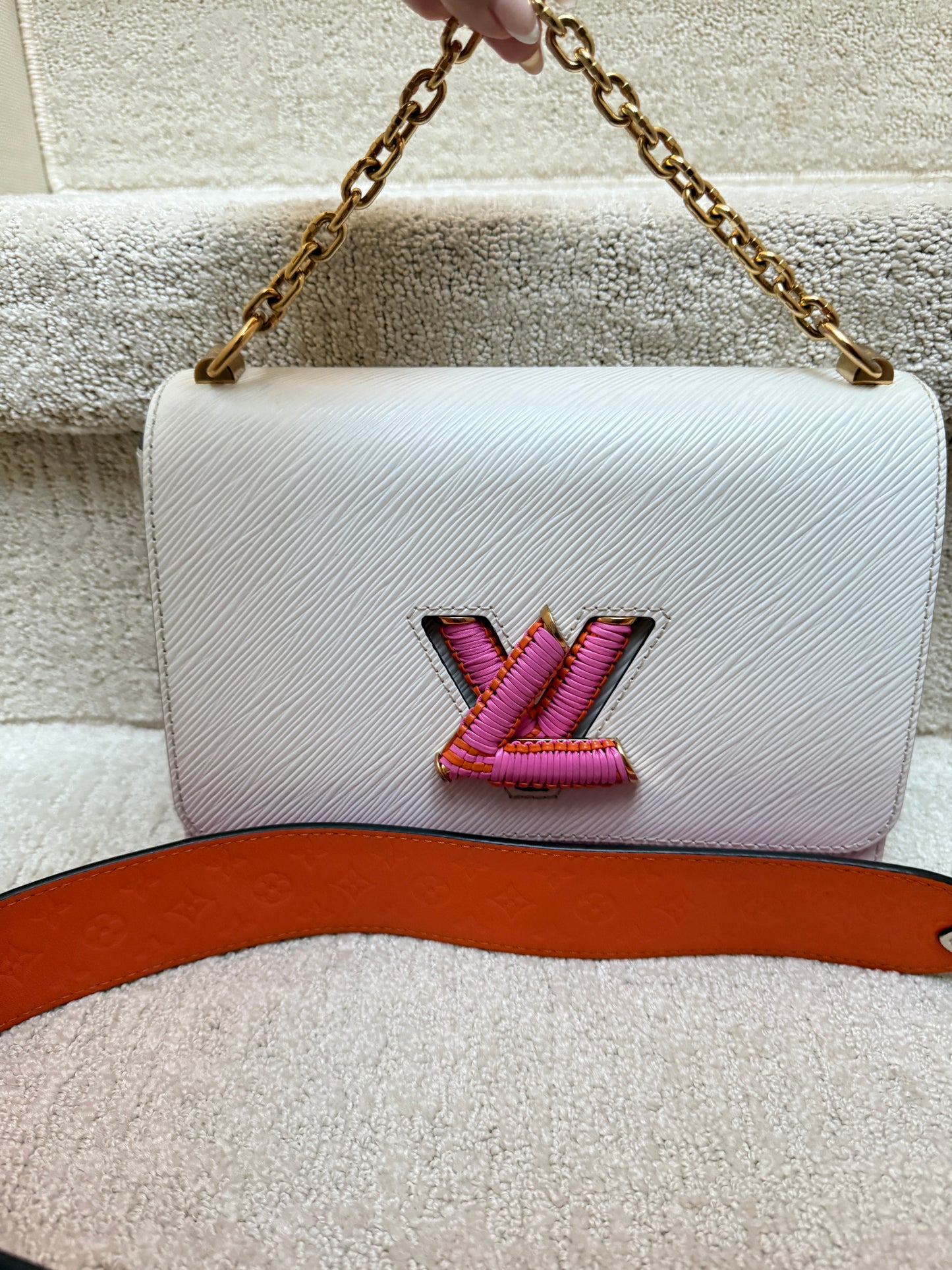 Front View of authenticated Louis Vuitton Twist handbag in White Epi leather with pink and orange accents