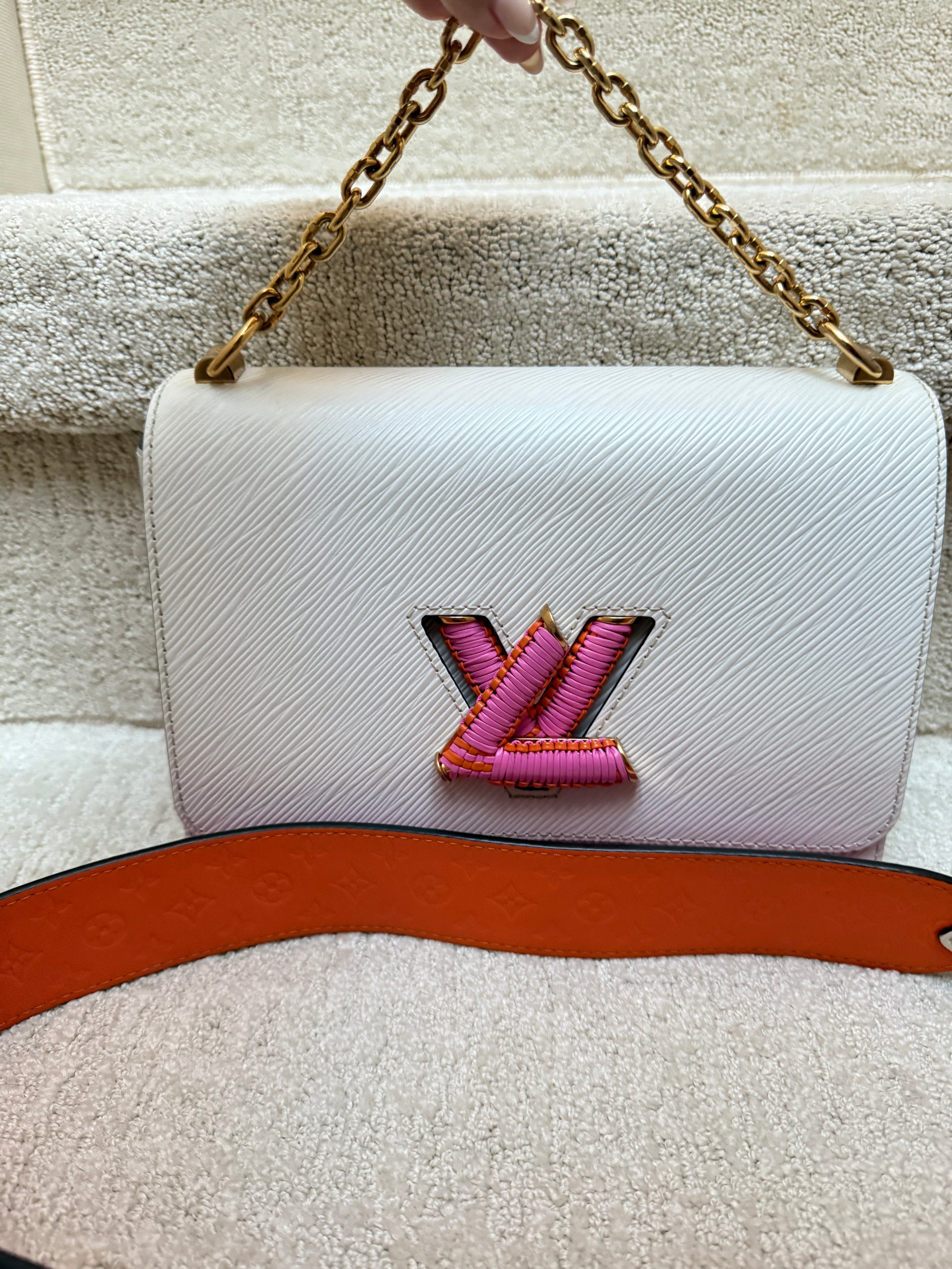 Front View of authenticated Louis Vuitton Twist handbag in White Epi leather with pink and orange accents